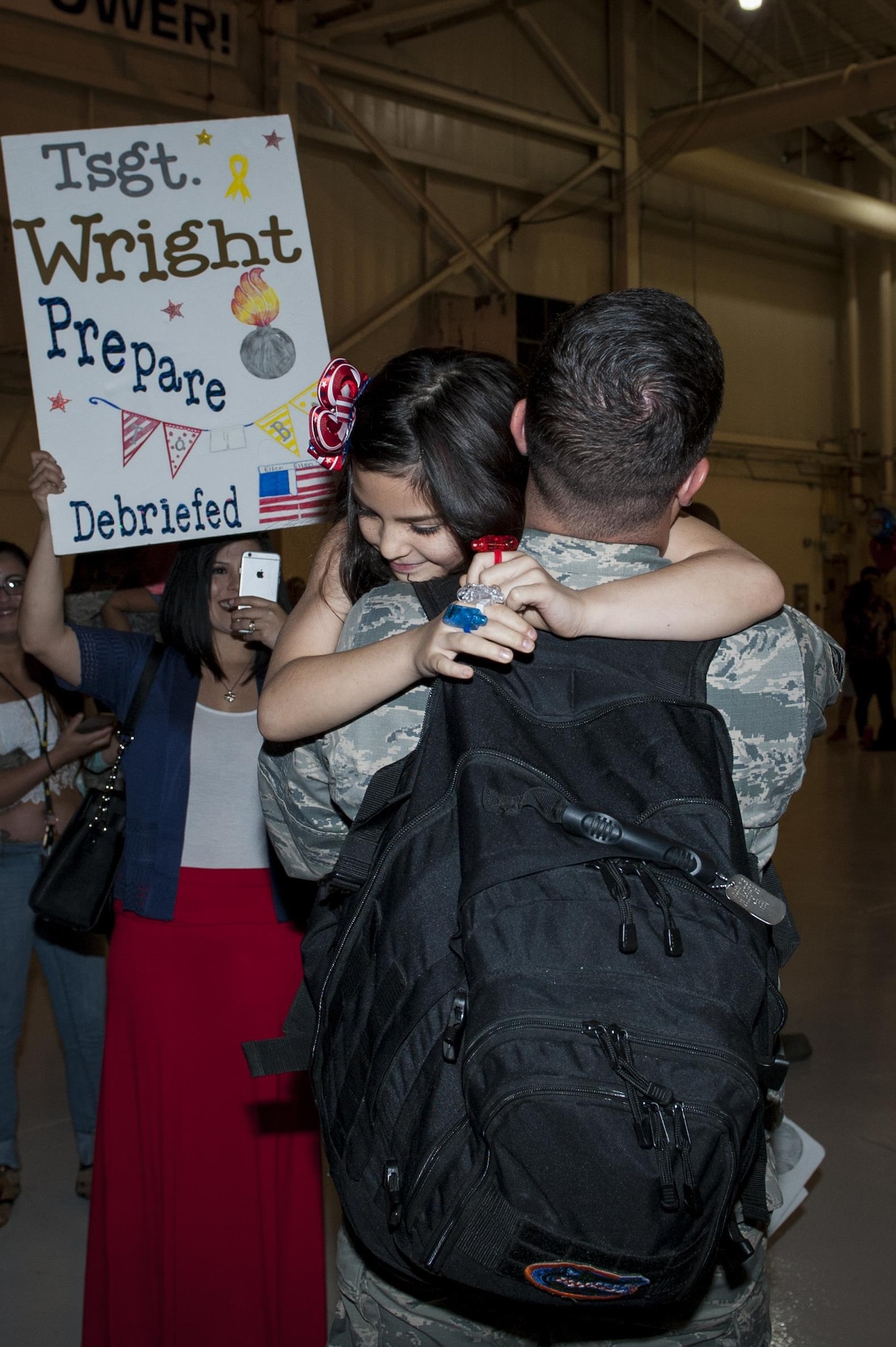 U.S. Air Force Tech. Sgt. Dennis Wright, 74th Expeditionary Fighter Squadron conventional maintenance crew chief, embraces his daughter, Jaci, during a redeployment, March 30, 2016, at Moody Air Force Base, Ga. The 74th EFS deployed to Eastern Europe to train with NATO partners and assure U.S. allies.  (U.S. Air Force photo by Airman 1st Class Lauren M. Hunter/Released)