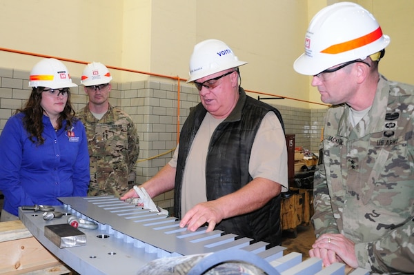 Martin Parker, site manager for Voith Hydro, explains the roles of a lamination sheet within a generator core with Maj. Gen. Donald Jackson during his visit to the Center Hill Hydropower Rehabilitation Project in Lancaster, Tenn., March 29, 2016.  