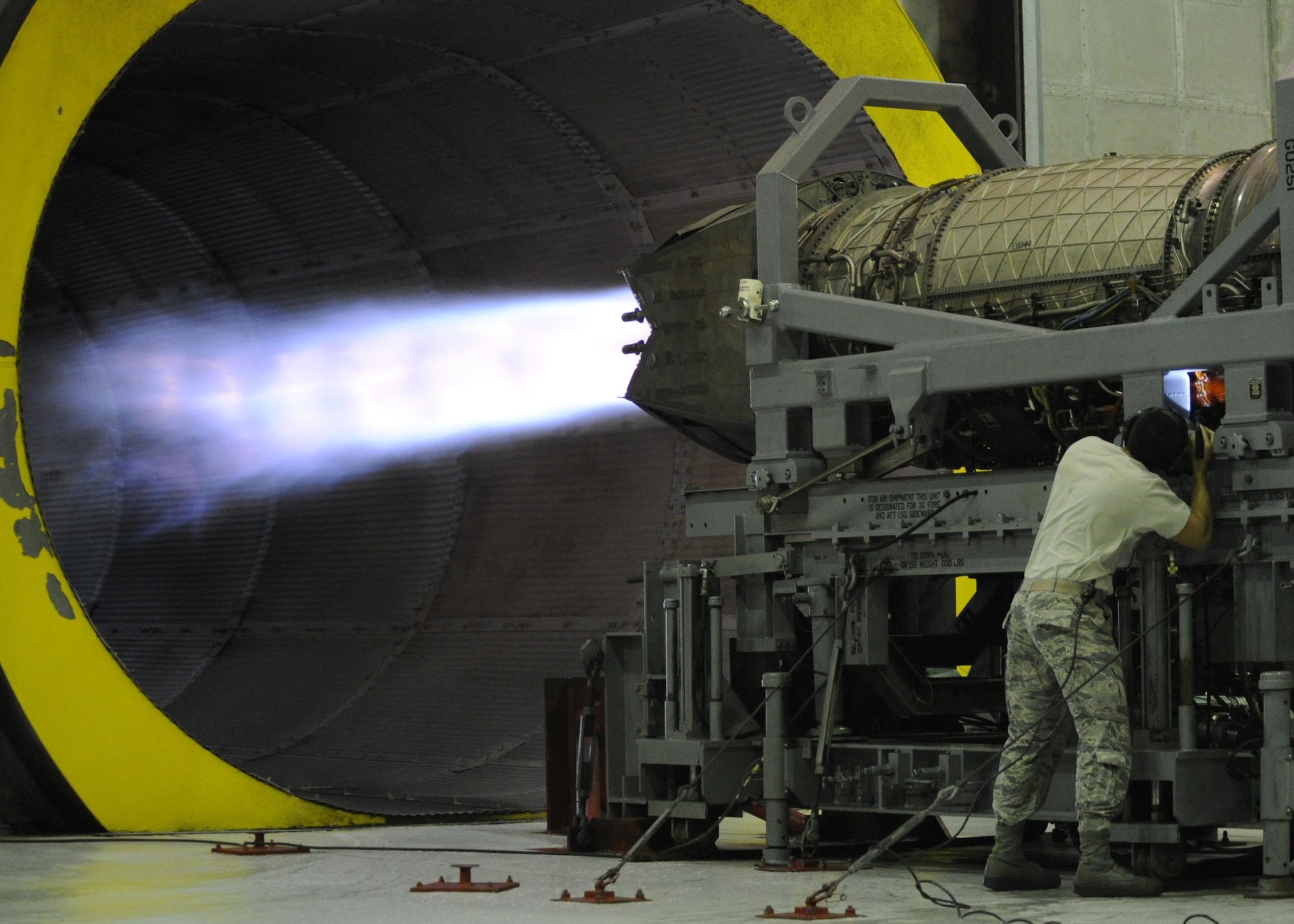 Senior Airman Matthew Garcia, 325th Maintenance Squadron aerospace propulsion journeyman looks for leaks coming from the F119-100 engine March 29, 2016, at test cell. During these tests and checks, F119-100 engines are turned on to full after burn to inspect its readiness. (U.S. Air Force photo by Senior Airman Solomon Cook/Released)