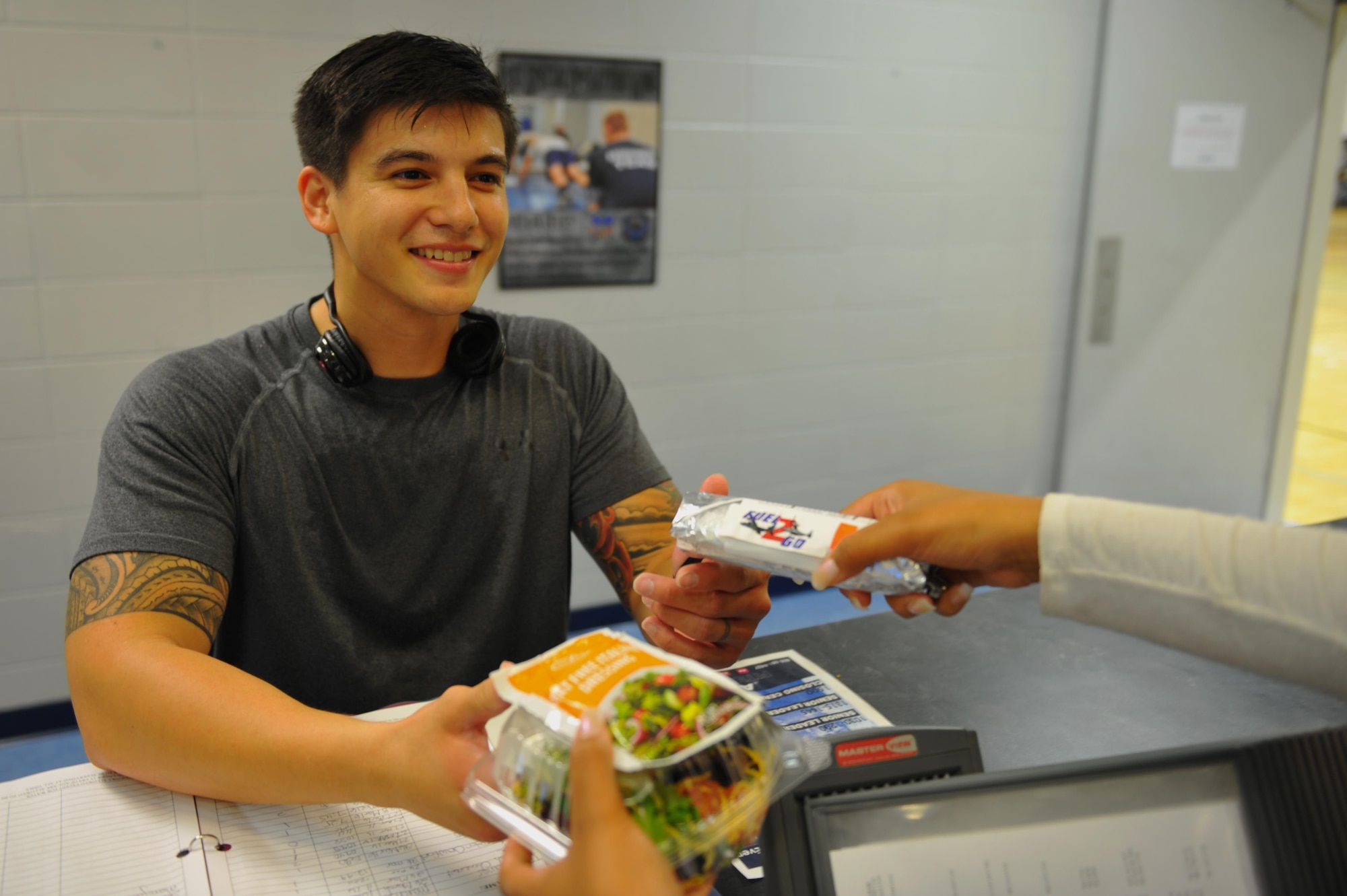 Staff Sgt. Reynaldo Corpuz, a special missions aviator with the 1st Special Operations Air Operations Squadron, purchases food from the “Fuel 2 Go” snack bar at the Aderholt Fitness Center, Hurlburt Field, Fla., March 30, 2016. The “Fuel 2 Go” snack bar opened March 30 and offers a variety of wraps, salads and parfaits. (U.S. Air Force photo by Airman 1st Class Joseph Pick)