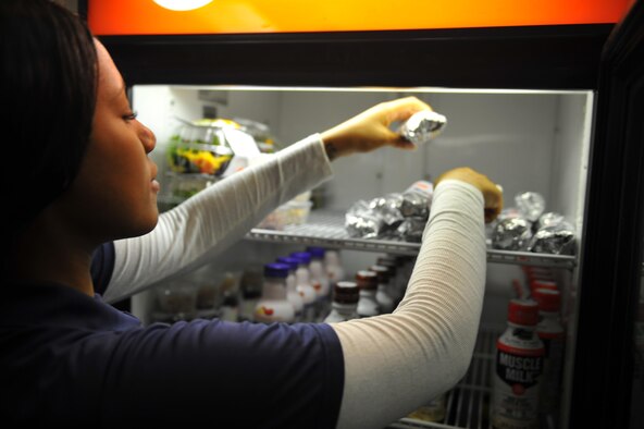 Airman 1st Class Alexus Barksdale, an operations specialist with the 1st Special Operations Force Support Squadron, reaches for a wrap at the Aderholt Fitness Center, Hurlburt Field, Fla., on March 30, 2016. The “Fuel 2 Go” snack bar opened March 30 and offers a variety of wraps, salads and parfaits. (U.S. Air Force photo by Airman 1st Class Joseph Pick)
