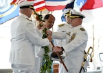 160330-N-LY160-308
JOINT BASE PEARL HARBOR-HICKAM, Hawaii (March 30, 2016) Commander William A. Patterson, right, presents ihe koa, a ceremonial warrior spear, to Cmdr. John C. Roussakies, commanding officer of the Virginia-class fast-attack submarine USS Hawaii (SSN 776), under the blessing from Kahu Kordell Kekoa during a change of command ceremony at the Battleship Missouri Memorial. (U.S. Navy photo by Mass Communication Specialist 2nd Class Michael H. Lee/Released)