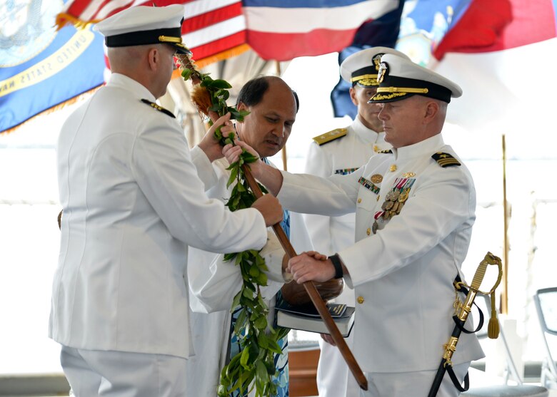 160330-N-LY160-308
JOINT BASE PEARL HARBOR-HICKAM, Hawaii (March 30, 2016) Commander William A. Patterson, right, presents ihe koa, a ceremonial warrior spear, to Cmdr. John C. Roussakies, commanding officer of the Virginia-class fast-attack submarine USS Hawaii (SSN 776), under the blessing from Kahu Kordell Kekoa during a change of command ceremony at the Battleship Missouri Memorial. (U.S. Navy photo by Mass Communication Specialist 2nd Class Michael H. Lee/Released)