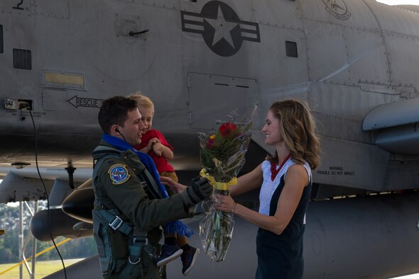 U.S. Air Force Capt. James Knauss, 74th Expeditionary Fighter Squadron A-10C Thunderbolt II pilot, greets his wife and son, James and Hannah, as he returns from a deployment, March 22, 2016, at Moody Air Force Base, Ga. Approximately 10 Moody A-10C Thunderbolt II’s contributed to multiple events and exercises while visiting 15 countries, conducting nearly 1,190 sorties in support of Operation Atlantic Resolve. (U.S. Air Force photo by Airman 1st Class Greg Nash/Released) 
