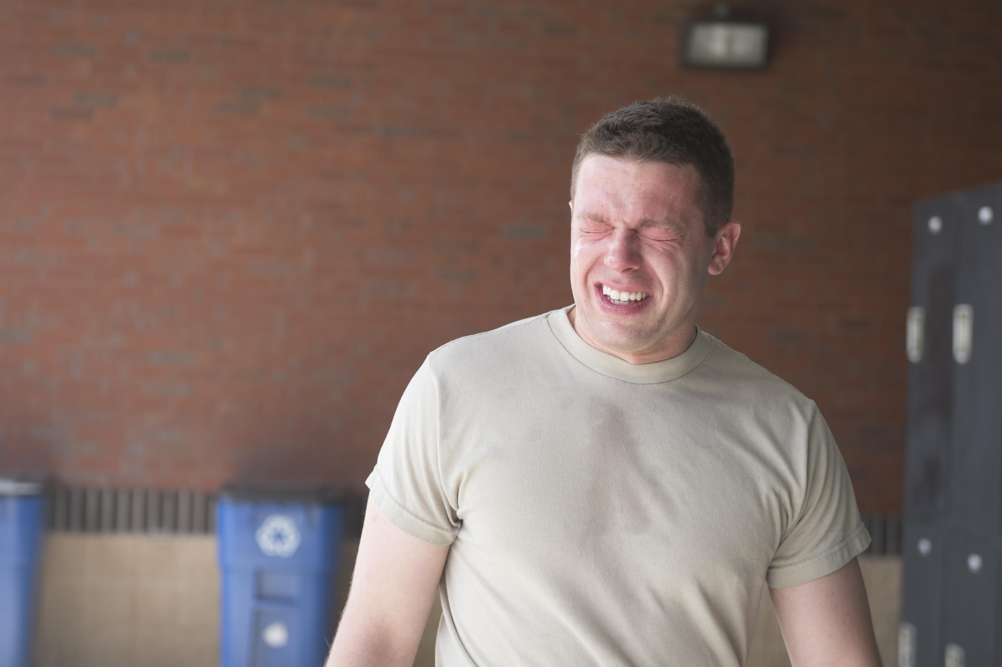 U.S. Air Force Airman Daniel Snider, 23d Wing Public Affairs photojournalist, paces after getting sprayed with oleoresin capsicum spray, March 11, 2016, at Moody Air Force Base, Ga. After being shocked with a Taser, Snider volunteered to be sprayed with OC spray, the law enforcement equivalent to pepper spray. (U.S. Air Force photo by Staff Sgt. Olivia Dominique/Released)