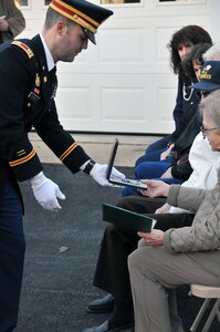 Capt. Joshua Koncar from the U.S. Army Reserve's 733rd Transportation Company in Reading, Pennsylvania, awards the Purple Heart on March 29 to Urbana Warfel, sister of Sgt. Wilson Meckley Jr.  Meckley was considered Missing in Action on Dec. 2, 1950 near the Chosin Reservoir, North Korea during the Korean War. On April 9, 2015, repatriated remains from the battlefield were analyzed, identifying them as Meckley's.