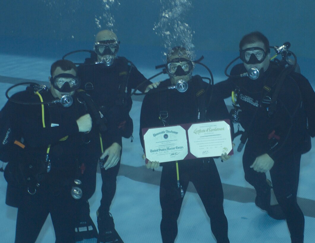 A Marine Raider with Marine Raider Regiment, U.S. Marine Corps Forces, Special Operations Command (MARSOC), conducted his re-enlistment ceremony while submerged underwater with his fellow Marine Raiders and re-enlistment officer at the MARSOC dive tank, aboard Stone Bay, Marine Corps Base Camp Lejeune, N.C., March 31, 2016. (U.S. Marine Corps Photo by Sgt. Scott A. Achtemeier / Released) 