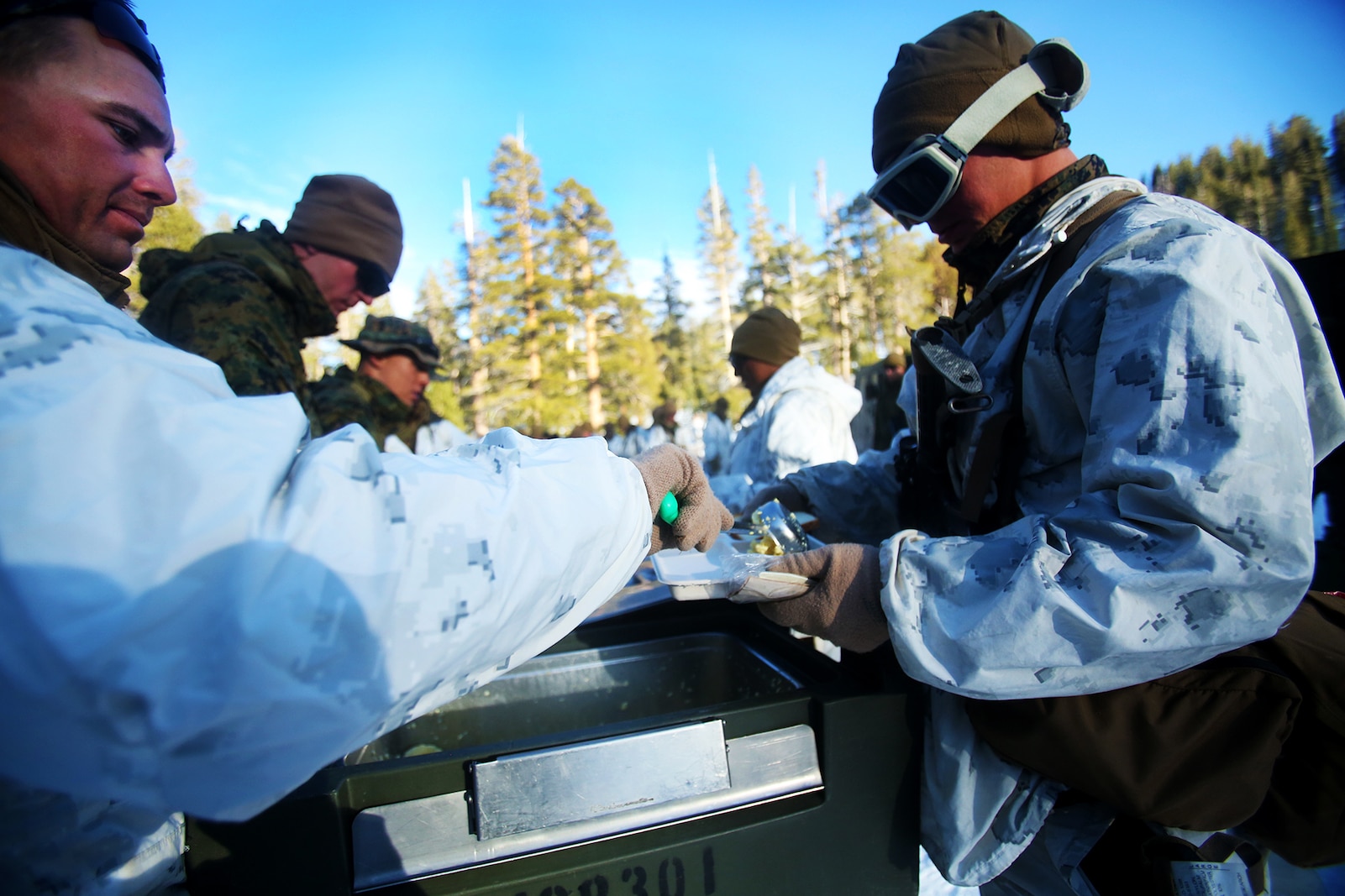 Marines are served warm food during a cold weather training exercise at the Mountain Warfare Training Center in Bridgeport, Calif., March 16, 2016. The Marines, combat engineers with 7th Engineer Support Battalion, 1st Marine Logistics Group, were among 90 Marines with 7th ESB who served as the logistics combat element in support of 2nd Battalion, 4th Marine Regiment, 1st Marine Division, during Mountain Exercise 6-16, Feb. 24- March 26, 2016. The Battalion integrated 18 combat engineers with the infantrymen conducting the exercise (U.S. Marine Corps photo by Sgt. Laura Gauna/released)