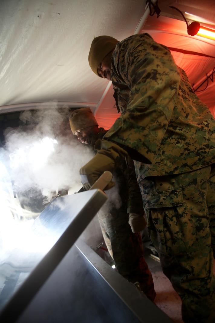 U.S. Marine Cpl. William Banks opens a freezer within the expeditionary field kitchen during a cold weather training exercise at the Mountain Warfare Training Center in Bridgeport, Calif., March 17, 2016. Banks, a food service specialist with Food Service Company, 1st Marine Logistics Group, was among 100 Marines with 1st MLG who served as the logistics combat element in support of 2nd Battalion, 4th Marine Regiment, 1st Marine Division, during Mountain Exercise 6-16, Feb. 24- March 26, 2016. (U.S. Marine Corps photo by Sgt. Laura Gauna/released)