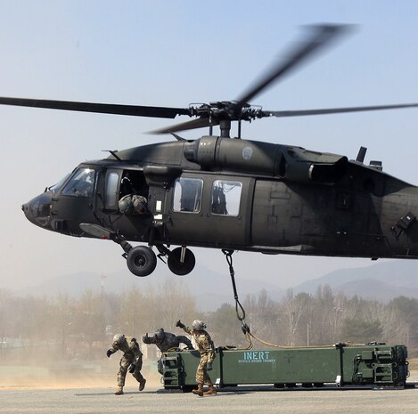 OSAN AIR BASE, South Korea – A team of Soldiers from 2nd Battalion, 1st Air Defense Artillery Regiment, signal a “thumbs up” to the 2-2 Assault Helicopter Battalion flight crew that it is clear to take off with a Missile Round Trainer connected via sling load method during a sling load training event held March 30, 2016, at Camp Carroll, South Korea. 