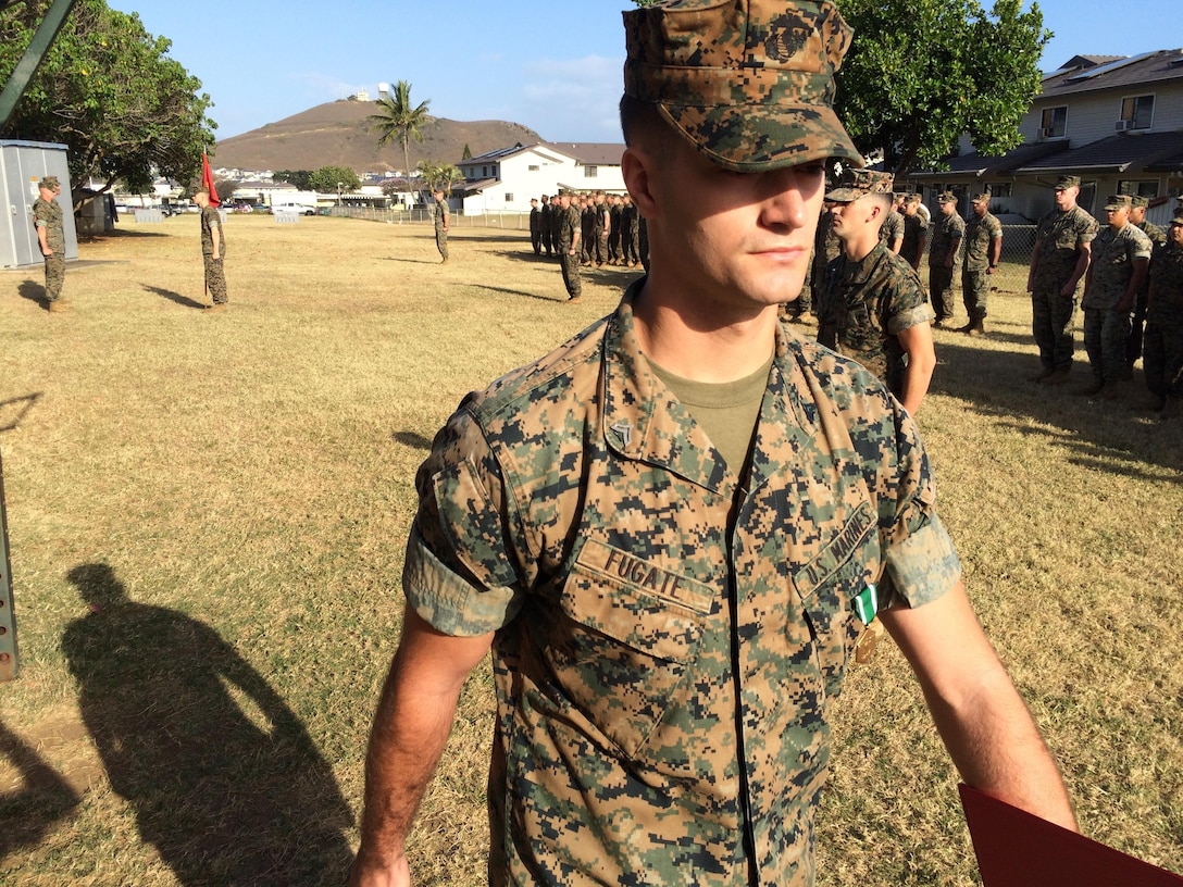 Cpl. Justin Fugate marches back into formation after being awarded the Navy and Marine Corps Commendation Medal for saving a U.S. Army parachutist that landed in the ocean and was trapped by coral and his own parachute.  Fugate is a 2009 graduate of St. Ignatius High School in Cleveland, Ohio and serves as an Electro-Optical Ordnance Repairman.
Cpl. Lester Cano was awarded the same medal moments before.  Cano and Fugate worked as a team on the rescue.
The Marines are assigned to Headquarters Company, 3d Marine Regiment and were awarded by Col. Carl Cooper and Sgt. Maj. Alfonso Via, March 30, on Marine Corps Base Hawaii. On Dec. 15, 2015 a U.S. soldier was blown off course from his drop zone by high winds and parachuted into the Pacific Ocean north of the Mokapu Peninsula that forms Marine Corps Base Hawaii on the island of Oahu. Fugate and Cano were running through the area during their Corporal's Course small unit leader evaluation. They noticed people pointing towards the water and then saw the parachutist. They worked together to develop a rescue plan. Cano improvised a safety line and swam 100 meters out to establish himself as the anchoring relay halfway between the trapped soldier and shore. Meanwhile, Fugate and a lifeguard spent the next hour swimming to reach the soldier where they then freed him from the entangled cordage and retrieved him to the shore. Once ashore, Cano rendered first aid and Fugate assisted until emergency medical services arrived.