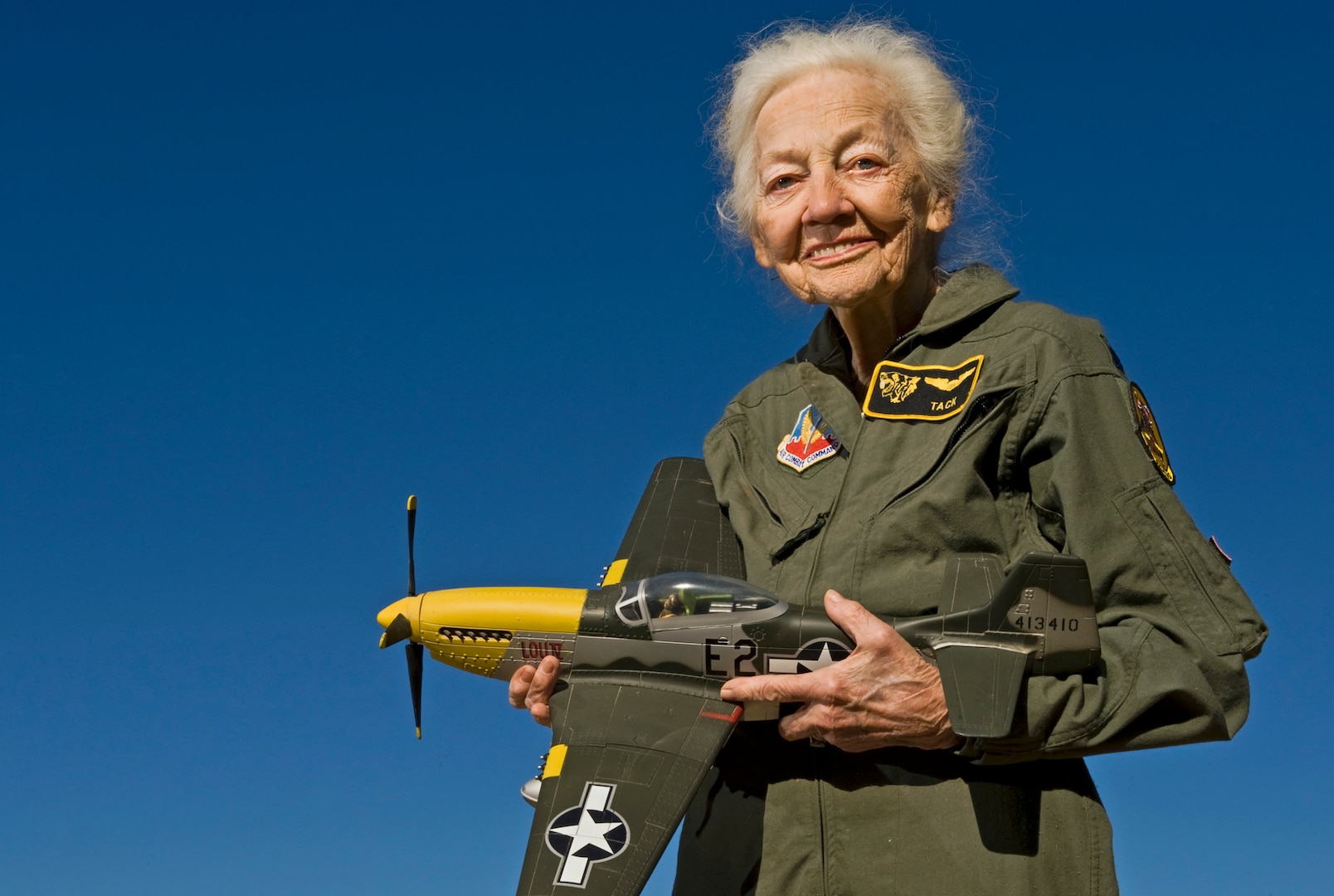 Betty "Tack" Blake, 91, holds a model of a P-51 Mustang, her favorite aircraft to fly, in front of her home in Scottsdale, Ariz. Blake joined the first class of WAFs (later named Women Airforce Service Pilots). During World War II, she was assigned as a transport pilot, ferrying 36 different types of aircraft across America.  (U.S. Air Force photo by Tech. Sgt. Bennie J. Davis III)
