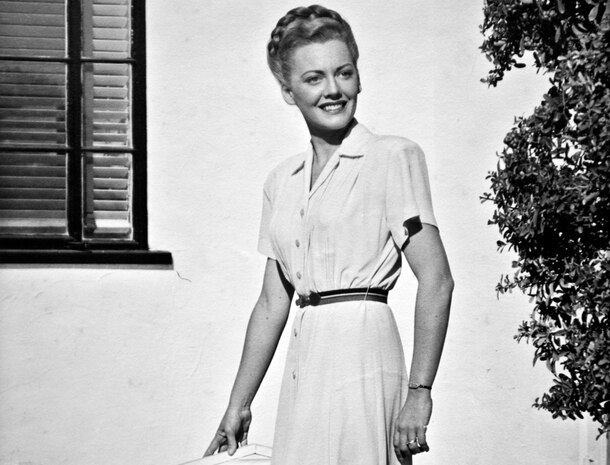 Betty Blake, 20 years old, stands in front of her family's home in Honolulu, Hawaii. Blake worked at the captain of the Navy yard's office and also flew tourists around the Hawaiian Islands as a commercial pilot before the attack on Pearl Harbor.  (U.S. Air Force photo by Tech. Sgt. Bennie J. Davis III)