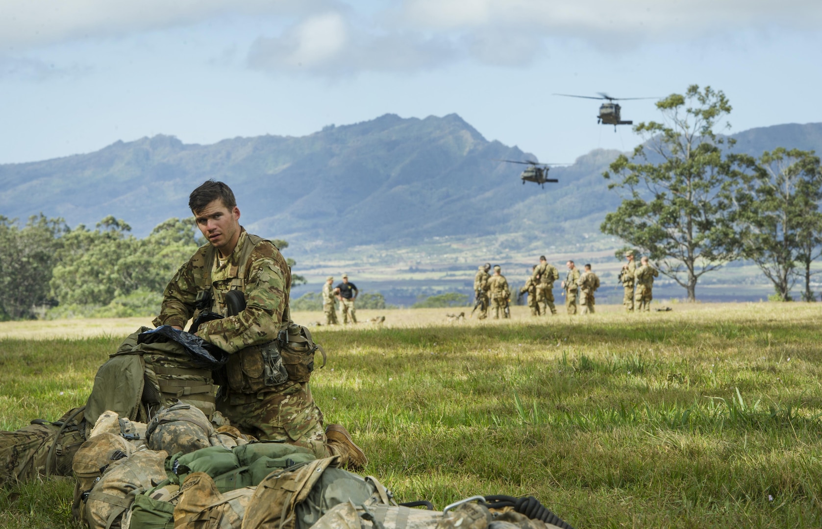 U.S. Army 1st Lt. Joseph Ross, 2nd Platoon, Alpha Company, 29th Engineer Battalion, 3rd Brigade, 25th Infantry Division, retrieves equipment from his ruck sack prior to participating in the 25th ID Lightning Academy’s Jungle Operations Training Center (JOTC) react to contact training lane March 17, 2016, at the East Range Training Center, Hawaii. Students who attend the JOTC training course learn how to operate in a jungle environment learning skills focused on survival, communication, navigation, waterborne and patrol base operations. Ross grew up in York, Pennsylvania and attributes stories he heard from his grandfather, a World War II veteran, in his decision to join the military. (U.S. Air Force photo by Staff Sgt. Christopher Hubenthal)