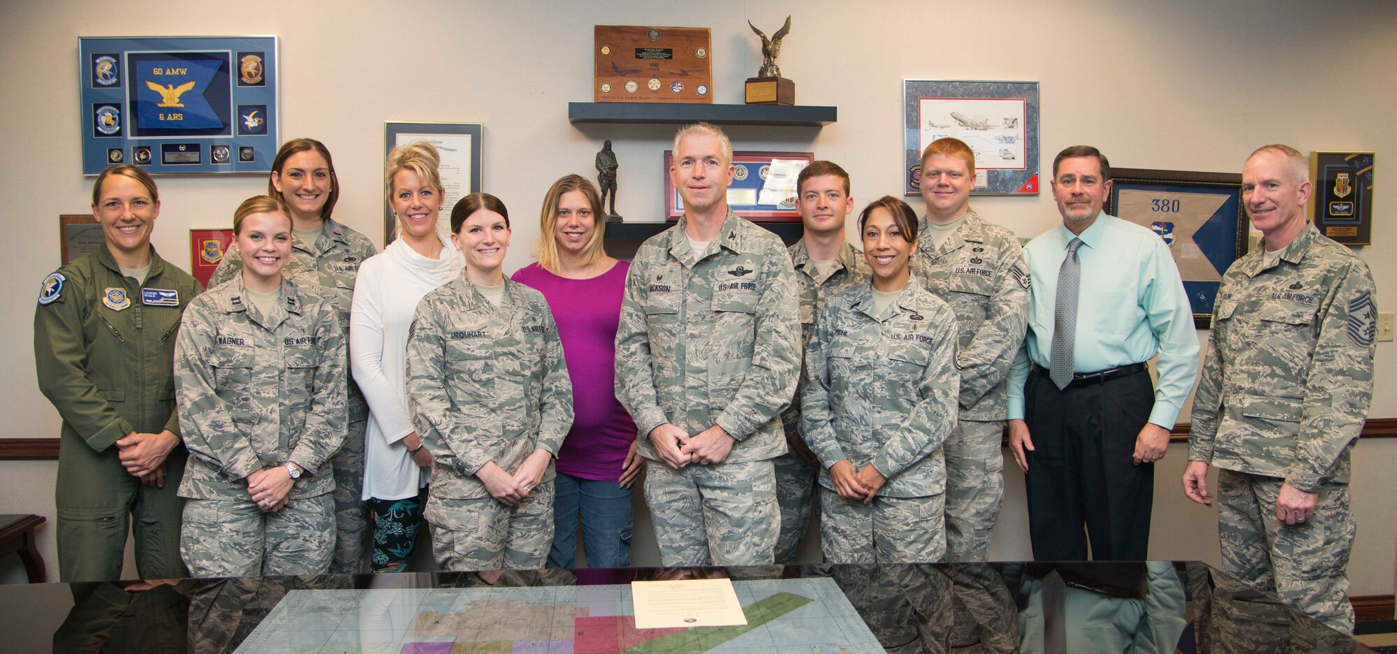 Col. Joel Jackson, seventh from the left, 60th Air Mobility Wing commander, and Chief Master Sgt. Alan Boling, right, 60th Air Mobility Wing command chief, stand with Kirk Whitman, 60th Air Mobility Wing installation sexual assault and response coordinator, and volunteer victim advocates after signing the Sexual Assault Awareness and Prevention Month proclamation in his office March 23, 2016 at Travis Air Force Base, Calif. The Travis SARC and VAs will be having various activities throughout the month of April for SAAPM. (U.S. Air Force photo/Senior Airman Nicole Leidholm)