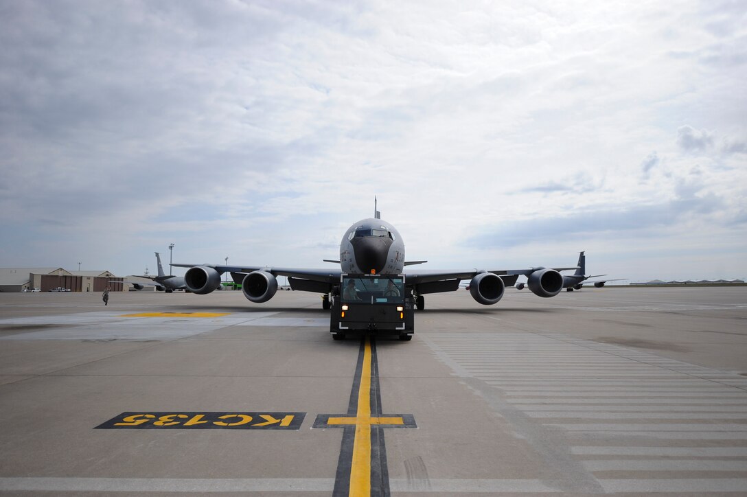 Airmen from the 22nd Aircraft Maintenance Squadron maneuver a KC-135 Stratotanker into a parking spot using an MB-2 tow tractor, March 29, 2016, at McConnell Air Force Base, Kan. The tow tractor is used to transport aircraft across the flightline without powering on the aircraft, conserving energy resources. (U.S. Air Force photo/Senior Airman Victor J. Caputo)