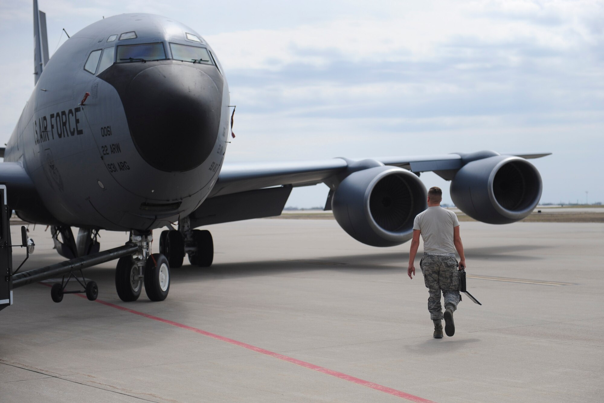 Staff Sgt. Austin Weber, 22nd Aircraft Maintenance Squadron crew chief, walks alongside a KC-135 Stratotanker as his crew prepares to tow it to a different parking spot across the flightline, March 29, 2016, at McConnell Air Force Base, Kan. Weber, as the ranking member of the team, was responsible for ensuring proper protocol was followed while the aircraft was in transit. (U.S. Air Force photo/Senior Airman Victor J. Caputo)