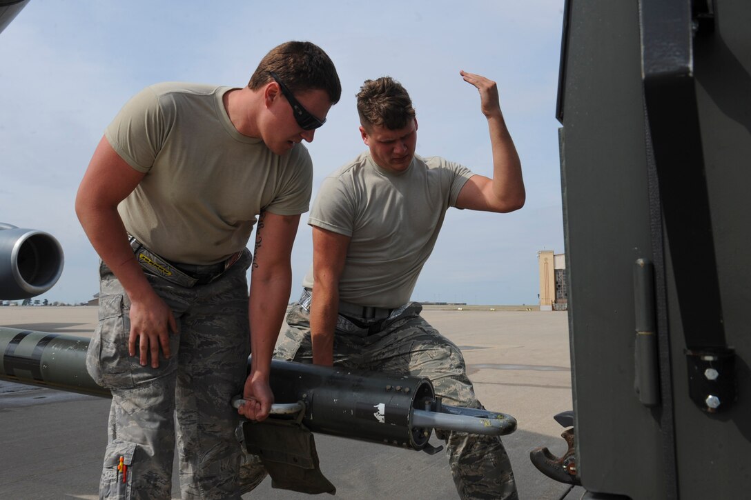 Airman 1st Class Garrett Jornov, left, and Staff Sgt. Austin Weber, 22nd Aircraft Maintenance Squadron crew chiefs, position a tow bar onto an MB-2 tow tractor, March 29, 2016, at McConnell Air Force Base, Kan. The tow tractor is used to transport KC-135 Stratotankers from one spot to another without powering on the aircraft. (U.S. Air Force photo/Senior Airman Victor J. Caputo)