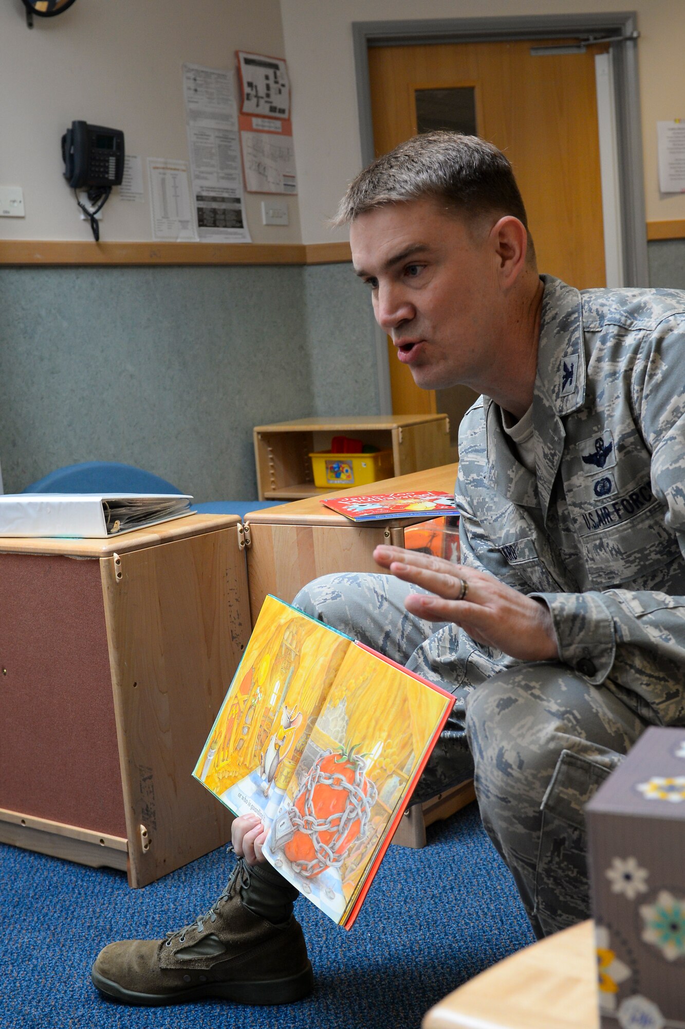 U.S. Air Force Col. John Howard 100th Air Refueling Wing vice commander, reads to children at the Child Development Center March 29, 2016, on RAF Mildenhall, England. Howard along with Col. Thomas D. Torkelson, 100th ARW commander, and Chief Master Sgt. Anthony Cruz-Munoz, 100th ARW command chief, read to the children in celebration of Dr. Seuss’ birthday. (U.S. Air Force photo by Staff Sgt. Micaiah Anthony/Released)