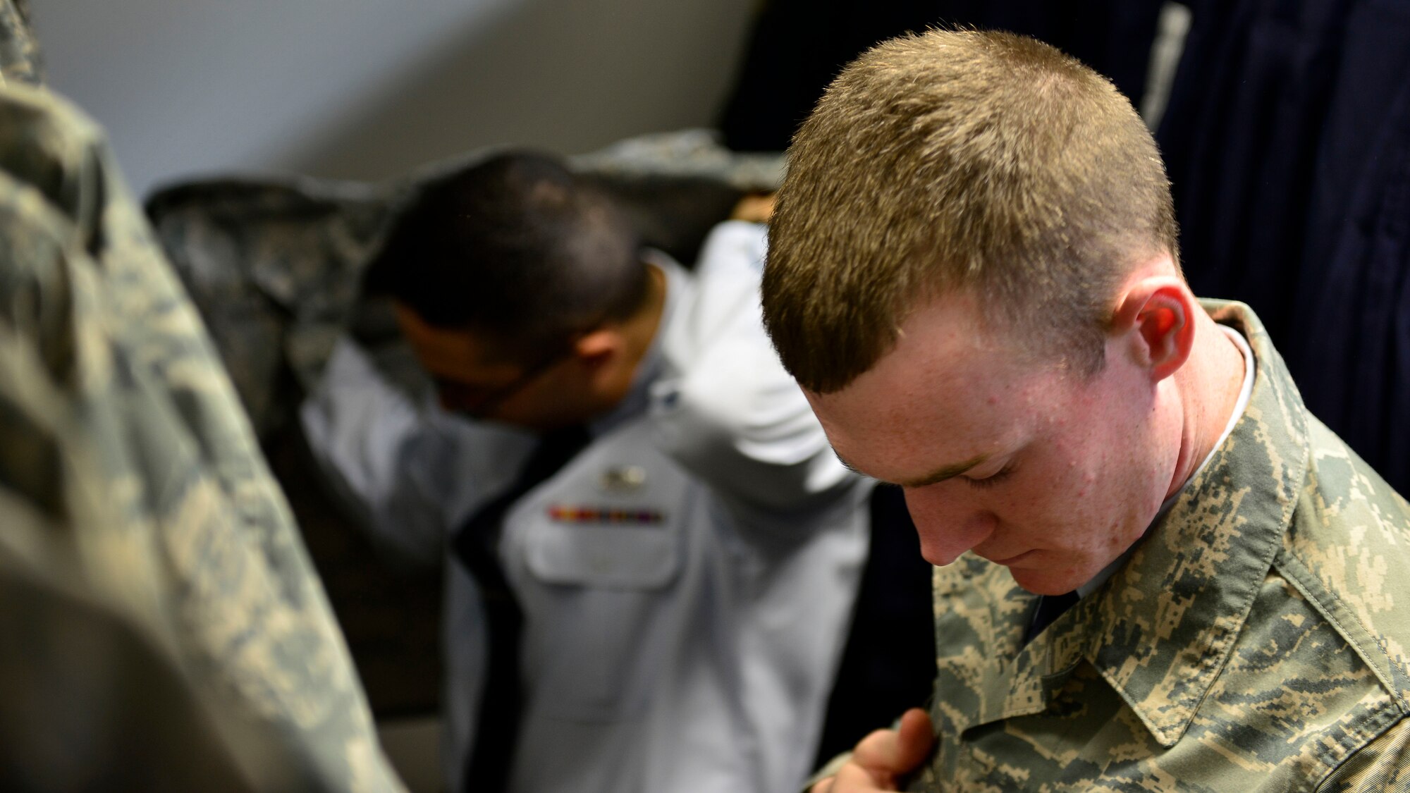 Airman 1st Class Colten Hazelip, 31st Maintenance Squadron Aerospace Ground Equipment technician, tries on a free serviceable uniform top, March 29, 2016, at Aviano Air Base, Italy. The Aviano Airman’s Attic is located in Bldg. 1467, and has free donated items available to all Team Aviano members. (U.S. Air Force photo by Airman 1st Class Cary Smith/Released)