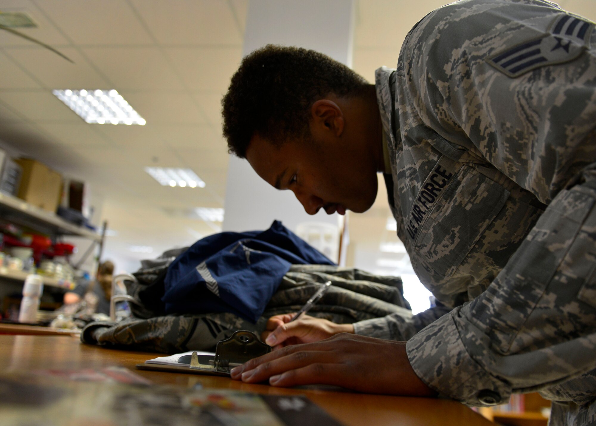 Senior Airman Ronald Sloane, 31st Logistics Readiness Squadron material management supply technician, signs out at the Aviano Airman’s Attic, March 29, 2016, at Aviano Air Base, Italy. Team Aviano members are provided different options to donate unneeded household goods to the local community. (U.S. Air Force photo by Airman 1st Class Cary Smith/Released)