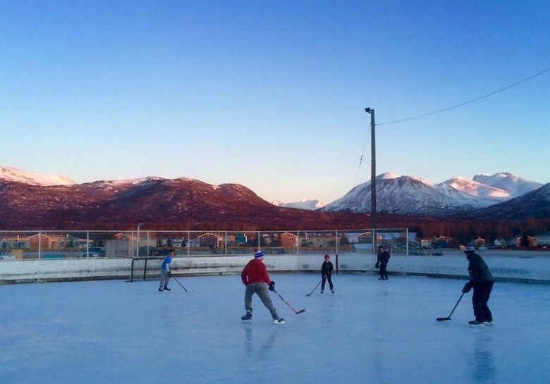 Family members and Army and Air Force personnel play hockey at Buckner Physical Fitness Center, Feb. 23, 2016. (U.S. Air Force photo by Senior Airman James Richardson)