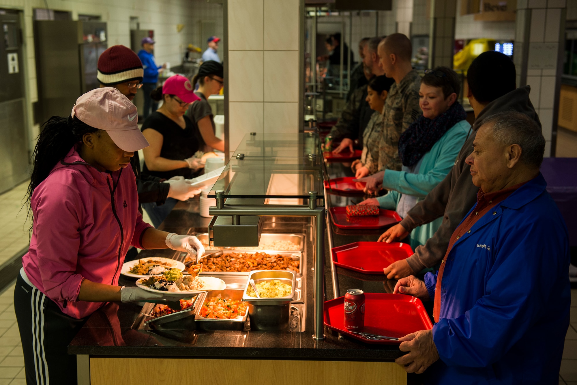 Members of the 52nd Force Support Squadron serve food to community members during the Messlords luncheon at the Mosel Dining Facility at Spangdahlem Air Base, Germany, March 30, 2016. More than 400 community members participated in the luncheon which consisted of Baja-themed dishes. (U.S. Air Force photo by Senior Airman Luke Kitterman/Released)