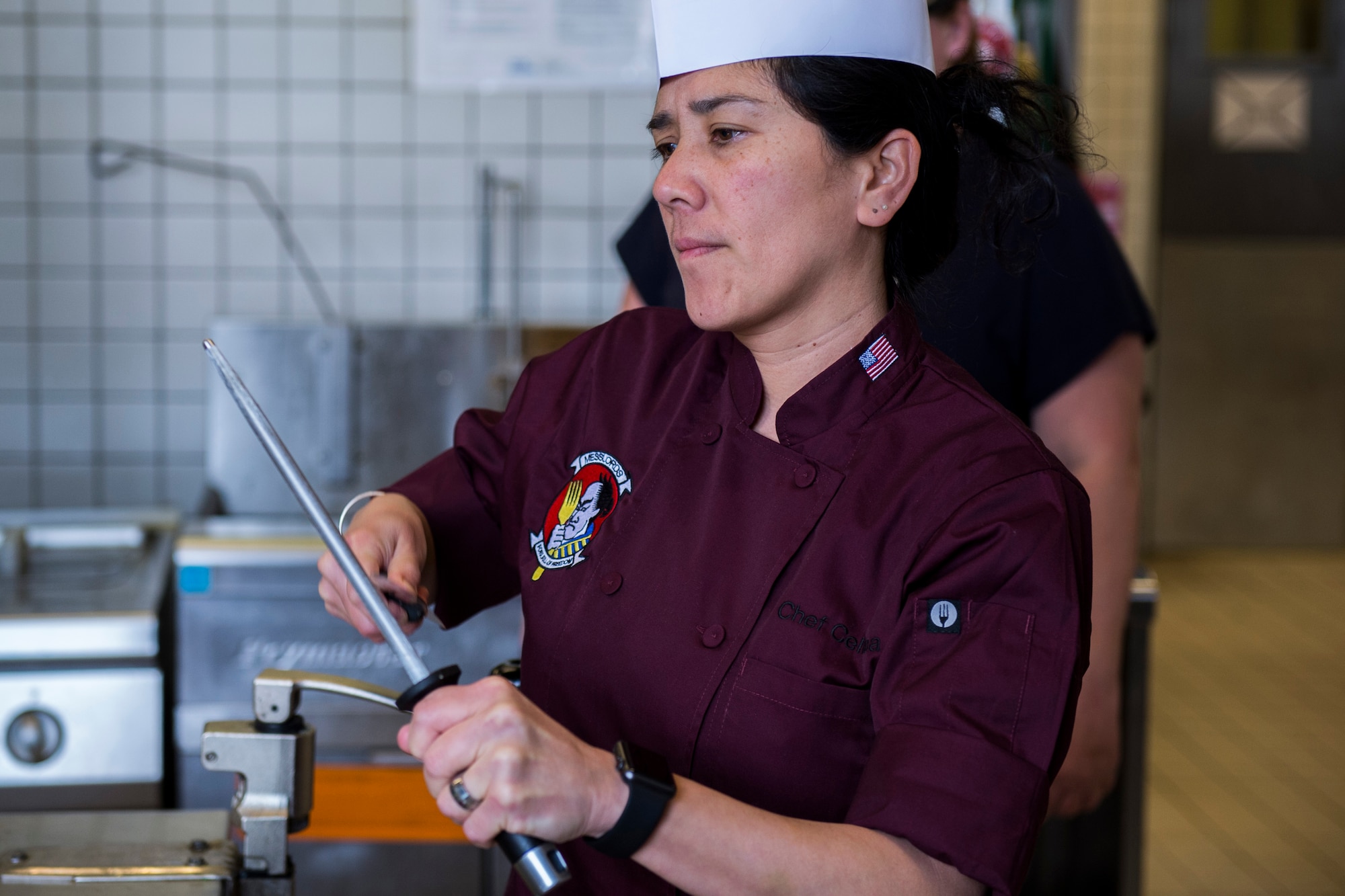 Celina Tio, a Messlords member, sharpens a knife in the kitchen of the Mosel Dining Facility at Spangdahlem Air Base, Germany, March 29, 2016. Tio, owner of restaurant ‘Julian’ in Kansas City, Mo., has competed on cooking shows like Food Network’s “The Iron Chef” and Bravo’s “Top Chef Masters.” (U.S. Air Force photo by Senior Airman Luke Kitterman/Released)