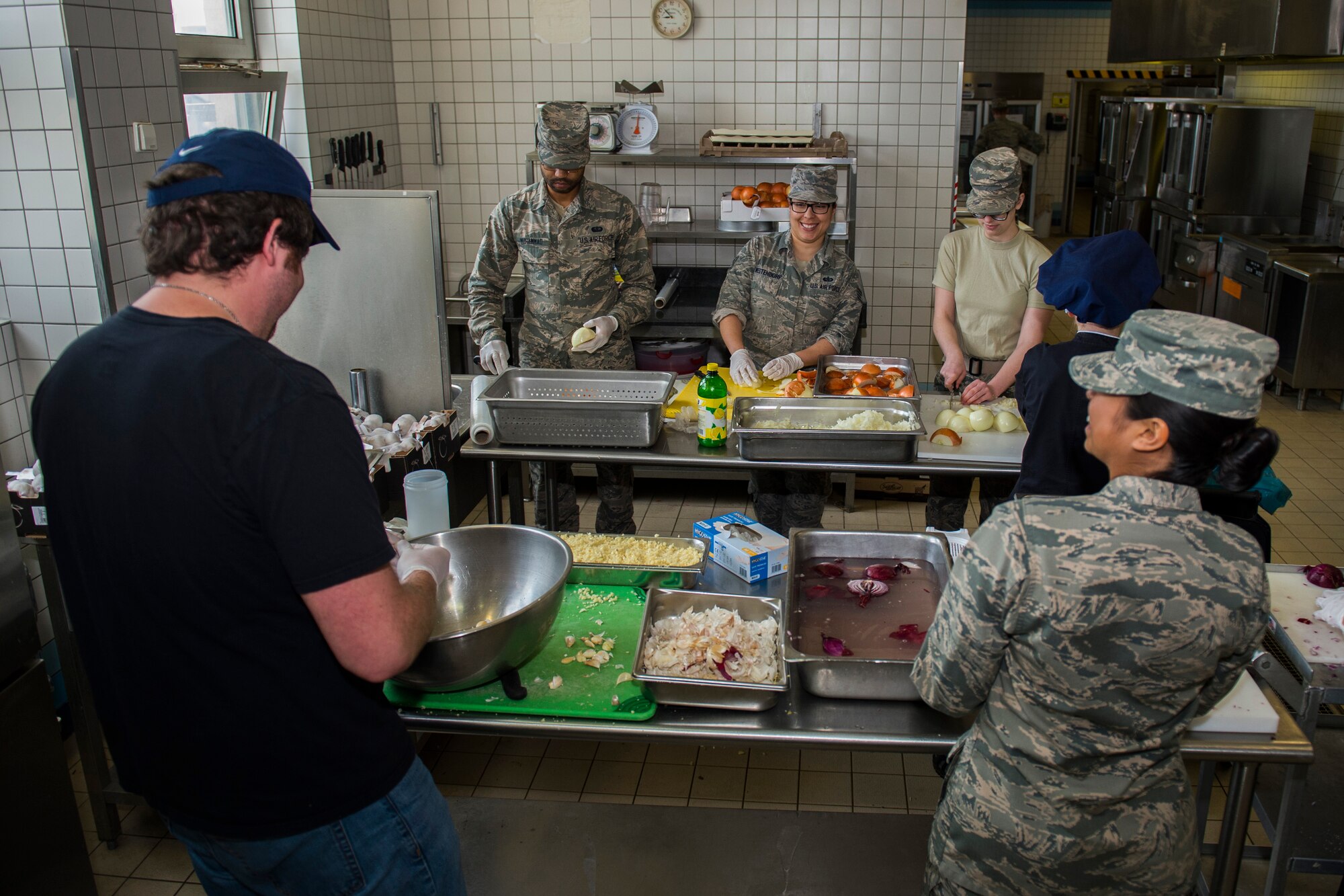 Members of the 52nd Force Support Squadron prepare food in the kitchen of the Mosel Dining Facility at Spangdahlem Air Base, Germany, March 29, 2016. More than 25 members of the 52nd FSS coordinated the Messlords luncheon, an event involving three celebrity chefs providing lunch for the Spangdahlem community. (U.S. Air Force photo by Senior Airman Luke Kitterman/Released)