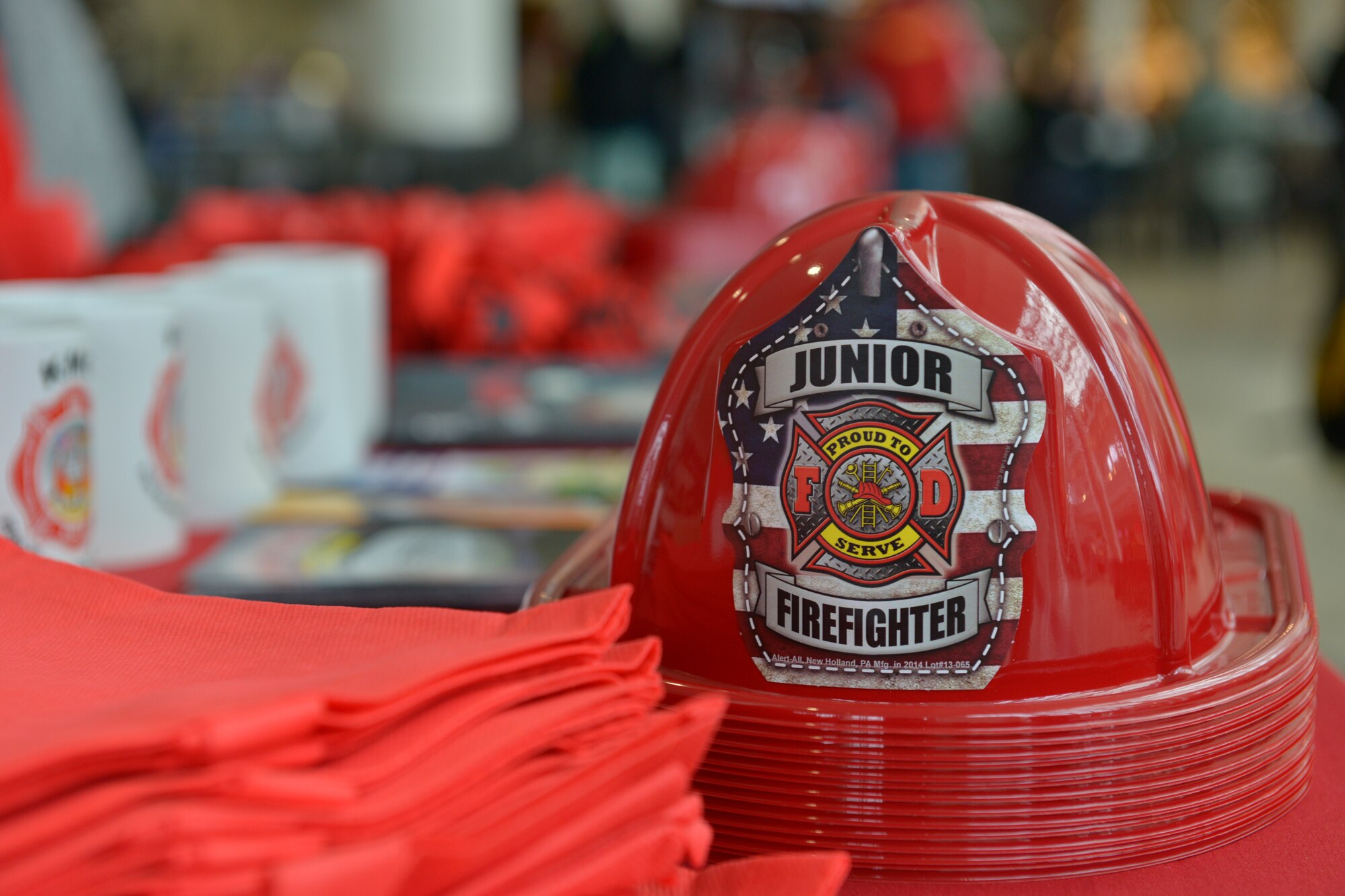 Plastic firefighter helmets and other memorabilia sit on display at a fire safety kiosk March 25, 2016, at Ramstein Air Base, Germany. The kiosk helped 86th Civil Engineer Squadron firefighters kick off the “Spring Into Fire Safety” initiative, which is designed to bring awareness to the new fire hazards that come with the spring season. (U.S. Air force photo/Airman 1st Class Lane T. Plummer)