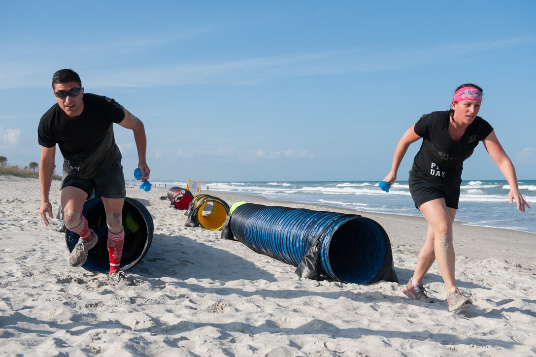 Members here participated in an Obstacle Mudd Race, March 30, 2016, at the Beach House at Patrick Air Force Base, Fla. The 45th Force Support Squadron Run Series included two-person teams, in which they ran, crawled, and climbed their way to the finish line. (U.S. Air Force photos/Benjamin Thacker) (Released) 