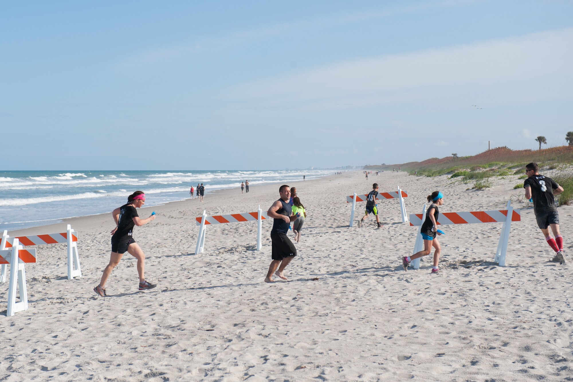 Members here participated in an Obstacle Mudd Race, March 30, 2016, at the Beach House at Patrick Air Force Base, Fla. The 45th Force Support Squadron Run Series included two-person teams, in which they ran, crawled, and climbed their way to the finish line. (U.S. Air Force photos/Benjamin Thacker) (Released) 