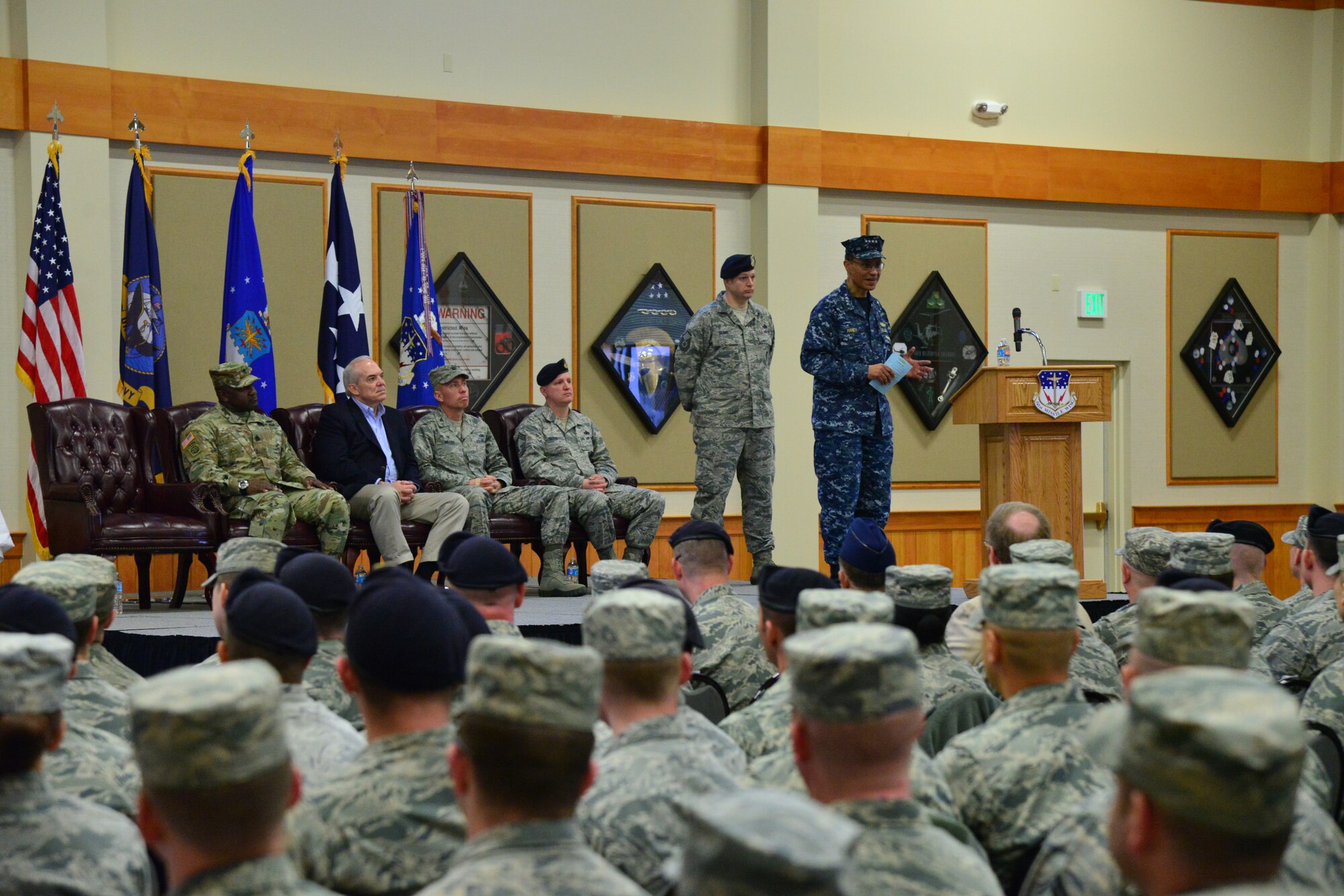 U.S. Navy Adm. Cecil D. Haney, U.S. Strategic Command (USSTRATCOM) commander (standing right), provides remarks during an award ceremony honoring the 341st Missile Wing at Malmstrom Air Force Base, Mont., March 30, 2016. During the ceremony, Haney and Mr. David G. Brown, Strategic Command Consultation (SCC) Committee member (seated, second from left), presented the 2015 Omaha Trophy, ICBM category, to U.S. Air Force Col. John T. Wilcox II, 341st Missile Wing commander (seated, second from right) and Team Malmstrom, in recognition of the wing's contributions to USSTRATCOM's global strategic missions. The Omaha Trophy, which dates back to the U.S. Air Force's Strategic Air Command, was originally created by the SCC in 1971. At the time, a single trophy was presented annually as a token of appreciation to USSTRATCOM's best wing. Since then, the tradition has evolved to unit-level awards that recognize the command's premier intercontinental ballistic missile (ICBM) wing, ballistic missile submarine, strategic bomber wing and global operations (space/cyberspace) unit. This year, a new category was added to include the combatant command's top strategic aircraft wing. (U.S. Air Force photo by Airman Daniel Brosam)