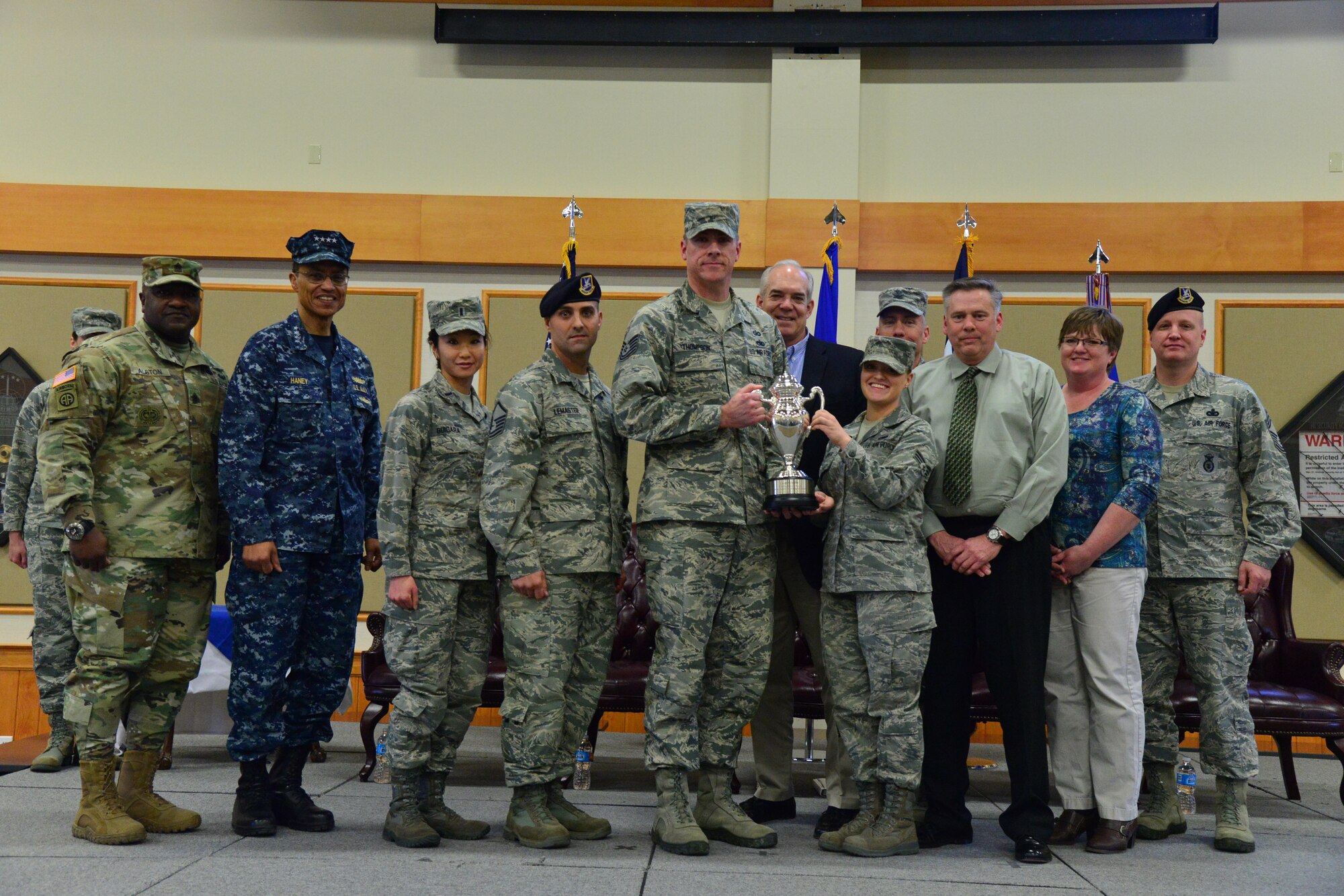 U.S. Navy Adm. Cecil D. Haney, U.S. Strategic Command (USSTRATCOM) commander (second from left); U.S. Army Command Sgt. Maj. Patrick Z. Alston, USSTRATCOM senior enlisted leader (left); and Mr. David G. Brown, Strategic Command Consultation (SCC) Committee member (center right), pose for a photo with Airmen and civilians after an award ceremony honoring the 341st Missile Wing at Malmstrom Air Force Base, Mont., March 30, 2016. During the ceremony, Haney and Brown presented the 2015 Omaha Trophy, ICBM category, to U.S. Air Force Col. John T. Wilcox II, 341st Missile Wing commander (not pictured) and Team Malmstrom, in recognition of the wing's contributions to USSTRATCOM's global strategic missions. The Omaha Trophy, which was originally created by the SCC in 1971, was presented to the wing in recognition of their contributions to USSTRATCOM's global strategic missions. At the time, a single trophy was presented annually as a token of appreciation to USSTRATCOM's best wing. Since then, the tradition has evolved to unit-level awards that recognize the command's premier ICBM wing, ballistic missile submarine, strategic bomber wing and global operations (space/cyberspace) unit. This year, a new category was added to include the combatant command's top strategic aircraft wing. (U.S. Air Force photo by Airman Daniel Brosam)