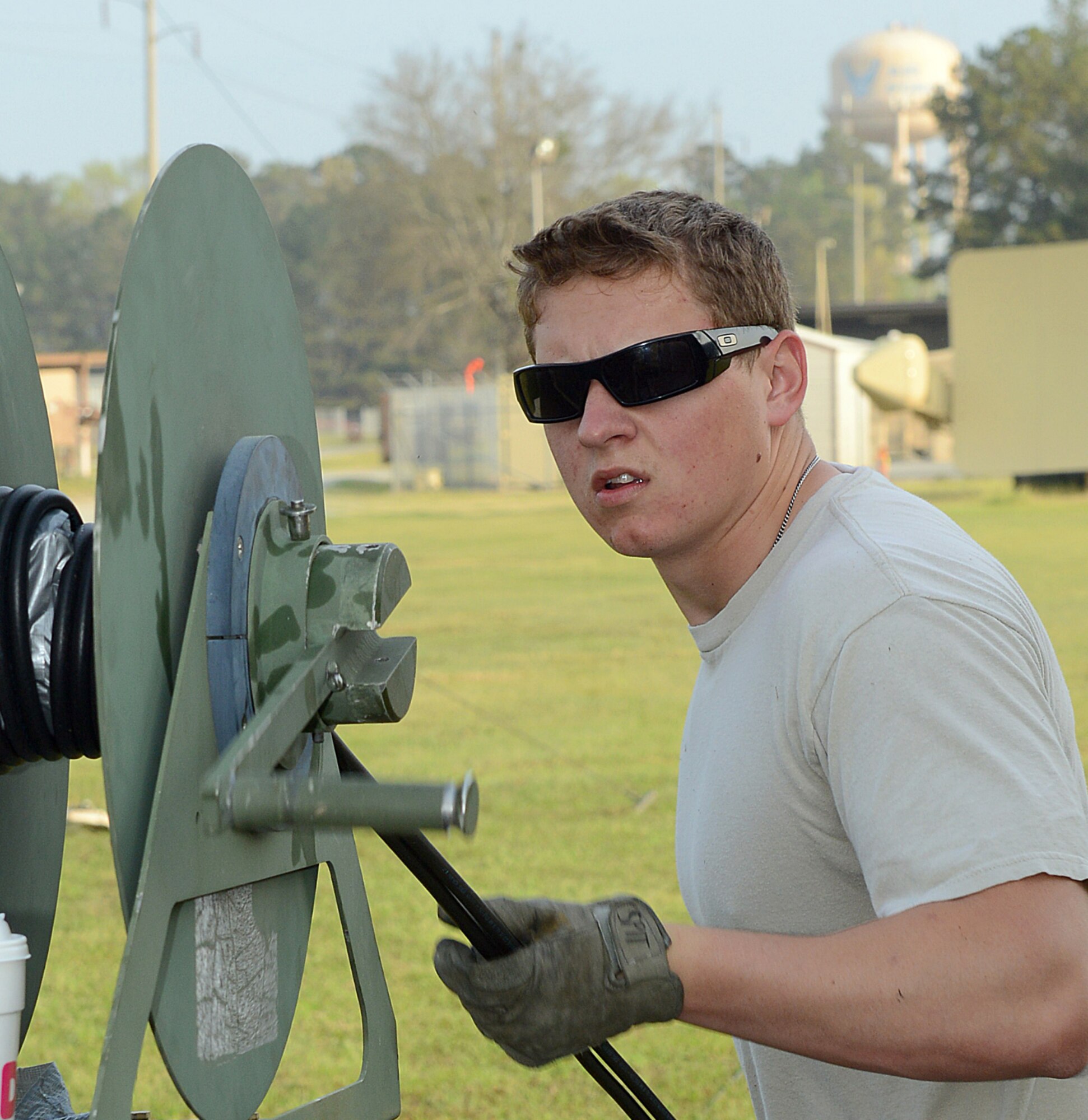 Senior Airman Adam Spittle, airfield systems technician, runs cable for the land mobile radio, March 17, 2016. (U.S. Air Force photo by Tommie Horton)