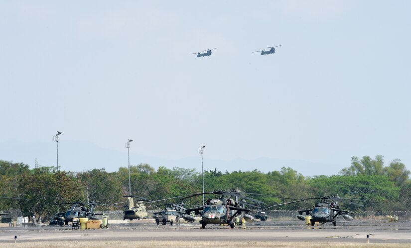 Two U.S. Army CH-47 Chinooks depart Soto Cano Air Base in support of firefighting efforts on the North coast of Honduras, Mar. 31, 2016, after Juan Orlando Hernandez, President of Honduras, sent a request for support to the U.S. Ambassador in Honduras. The helicopters provided assistance to the Honduran Air Force, Army and Fire Department, with a refillable, water carrying Bambi Bucket system and hoist capability to help retrieve people who may come under harm’s way on the ground. (U.S. Army photo by Martin Chahin/Released)