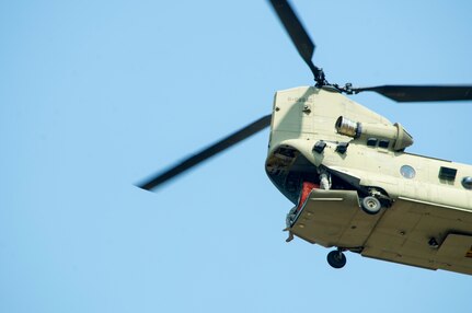 A U.S. Army CH-47 Chinook departs Soto Cano Air Base in support of firefighting efforts on the North coast of Honduras, Mar. 31, 2016, after Juan Orlando Hernandez, President of Honduras, sent a request for support to the U.S. Ambassador in Honduras. The helicopters, assigned to the 1-228th Aviation Regiment, maintain a Bambi Bucket capability, allowing them to support Honduran fire response forces fighting fires like those affecting the Jeanette Kawas National Park in northern Honduras. (U.S. Army photo by Martin Chahin/Released)