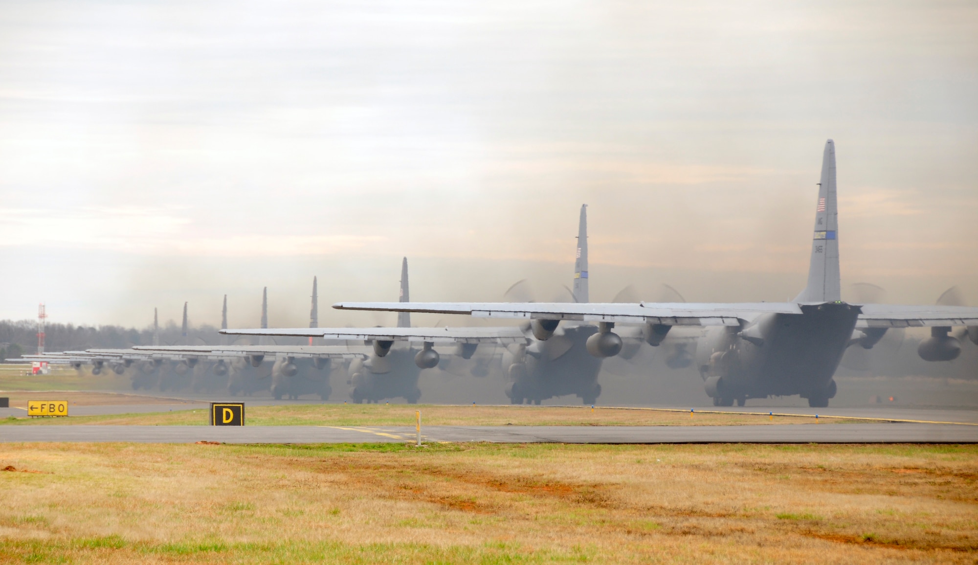 Nine C-130 Hercules aircraft assigned to the 145th Airlift Wing taxi out to runway in preparation for departure from the North Carolina Air National Guard Base, Charlotte Douglas International Airport, Feb. 7, 2016. Aircrew executed a tactical MAX flight launching all nine aircraft simultaneously. (U.S. Air National Guard photo by Master Sgt. Rich Kerner/Released)