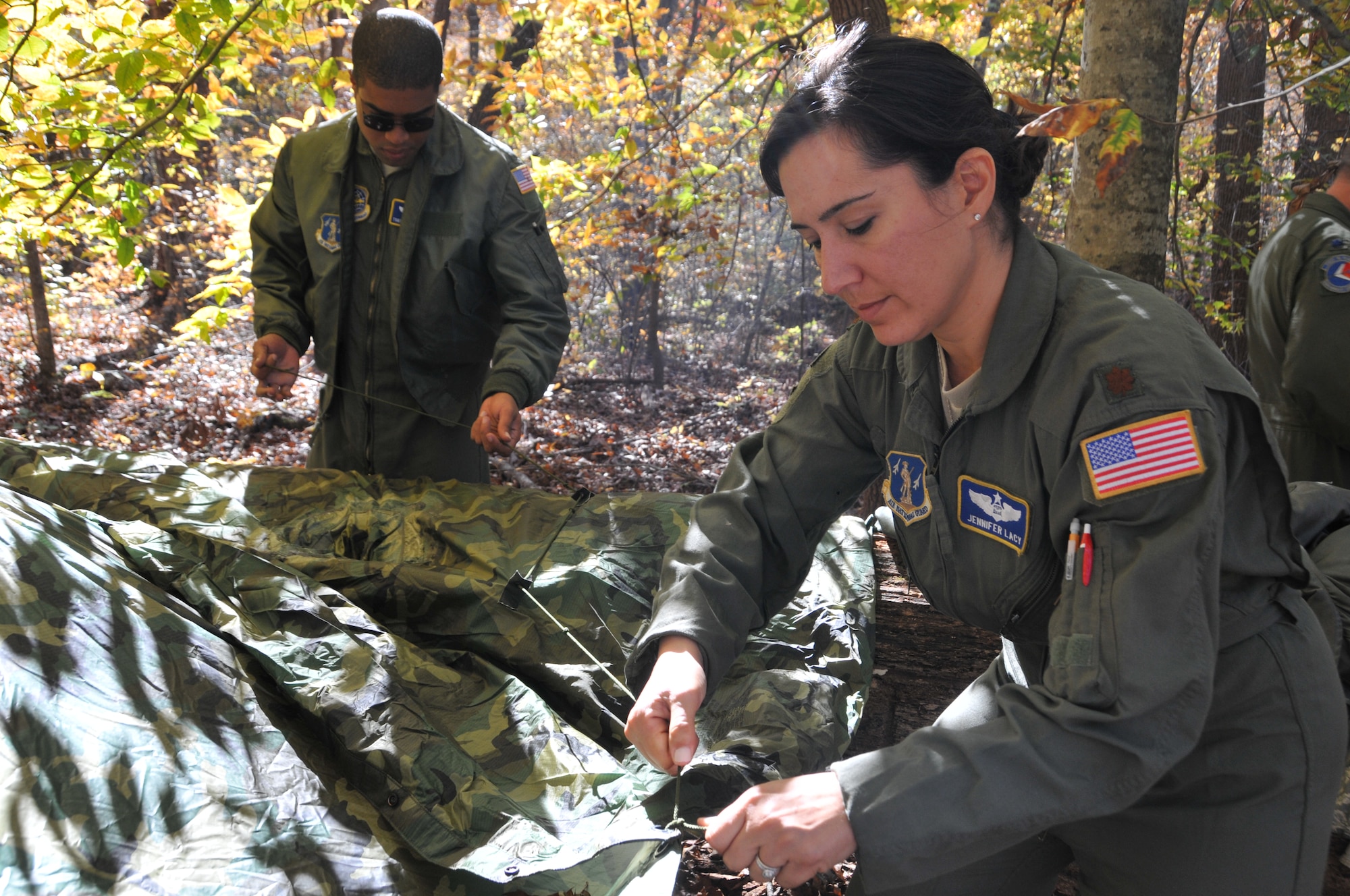 U.S. Air Force Maj. Jennifer Lacy builds a shelter during Combat Survival Refresher training held Nov. 3, 2013. This training aims to enhance the survivability and combat readiness of aircrew. Lacy has since been promoted to the rank of lieutenant colonel and currently serves as commander of the 145th Force Support Squadron. (U.S. Air National Guard photo by Master Sgt. Richard Kerner/Released)