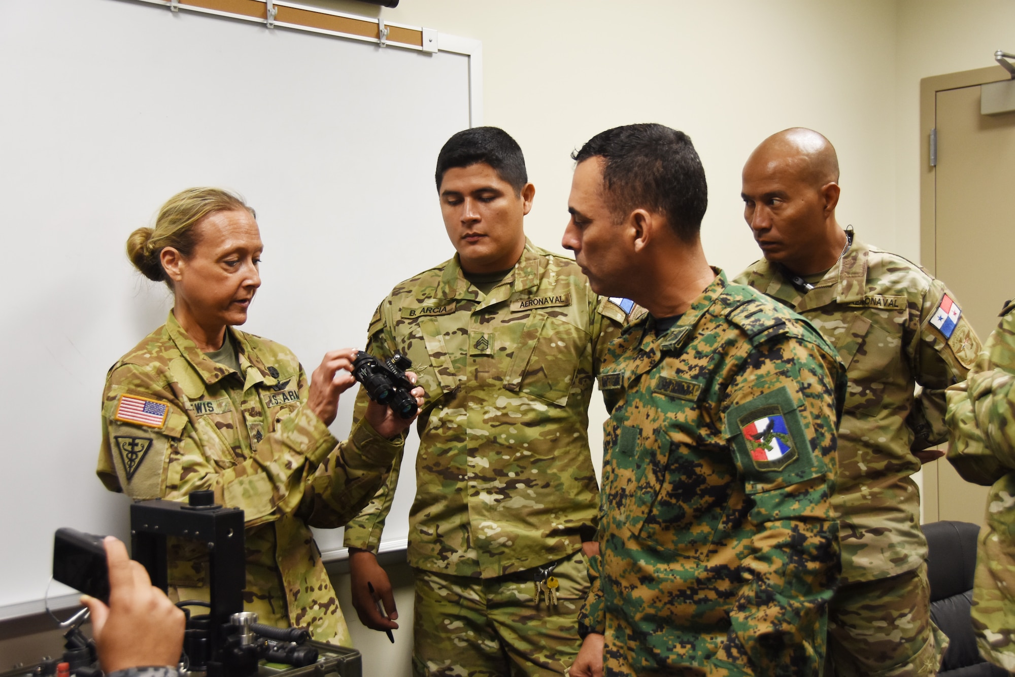 U.S. Army Staff Sgt. Michelle Lewis, an aviation life support equipment (ALSE) NCO technician assigned to the 1-135th Attack Reconnaissance Battalion, demonstrates proper maintenance procedures for Night Vision Goggles (NVGs) to members of the Panamanian Public Forces at Whiteman Air Force Base, Mo., March 16, 2016. The visit, part of the ongoing State Partnership Program between the Missouri National Guard and the Panamanian Public Forces, enabled subject matter exchanges between the two partners.
(U.S. Air National Guard photo by Senior Master Sgt. Mary-Dale Amison)
