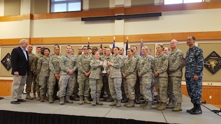 U.S. Navy Adm. Cecil D. Haney, U.S. Strategic Command (USSTRATCOM) commander (right), and Mr. David G. Brown, Strategic Command Consultation (SCC) Committee member (left), pose for a photo with U.S. Air Force Col. John T. Wilcox II, 341st Missile Wing commander (second from left) and Airmen of the 341st Missile Wing, after presenting the wing with the 2015 Omaha Trophy, ICBM category, at Malmstrom Air Force Base, Mont., March 30, 2016. The Omaha Trophy, which was originally created by the SCC in 1971, was presented to the wing in recognition of their contributions to USSTRATCOM's global strategic missions. At the time, a single trophy was presented annually as a token of appreciation to USSTRATCOM's best wing. Since then, the tradition has evolved to unit-level awards that recognize the command's premier ICBM wing, ballistic missile submarine, strategic bomber wing and global operations (space/cyberspace) unit. This year, a new category was added to include the combatant command's top strategic aircraft wing. (USSTRATCOM Photo by U.S. Air Force Maj. Matthew B. Miller)