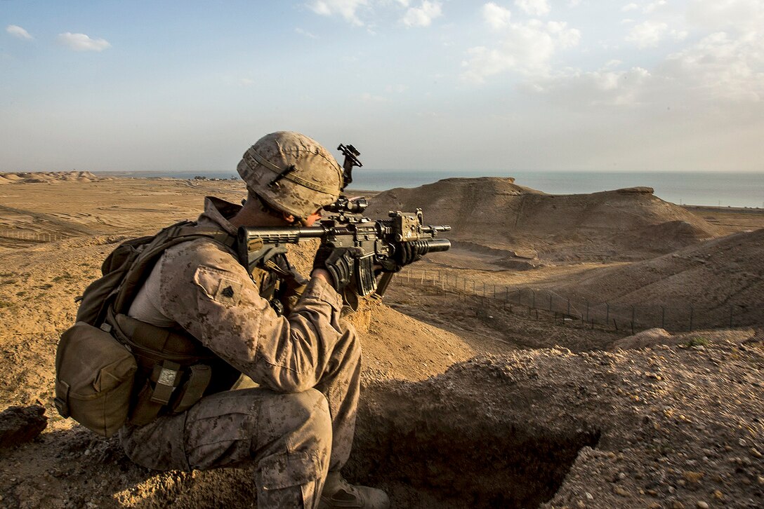 Marine Corps Sgt. Josh Greathouse scans the area during a perimeter patrol in Al Taqaddum, Iraq, March 21, 2016. Greathouse is  a team leader assigned to Bravo Company, 1st Battalion, 7th Marine Regiment, Special Purpose Marine Air Ground Task Force Crisis Response for U.S. Central Command. Marine Corps photo by Sgt. Rick Hurtado