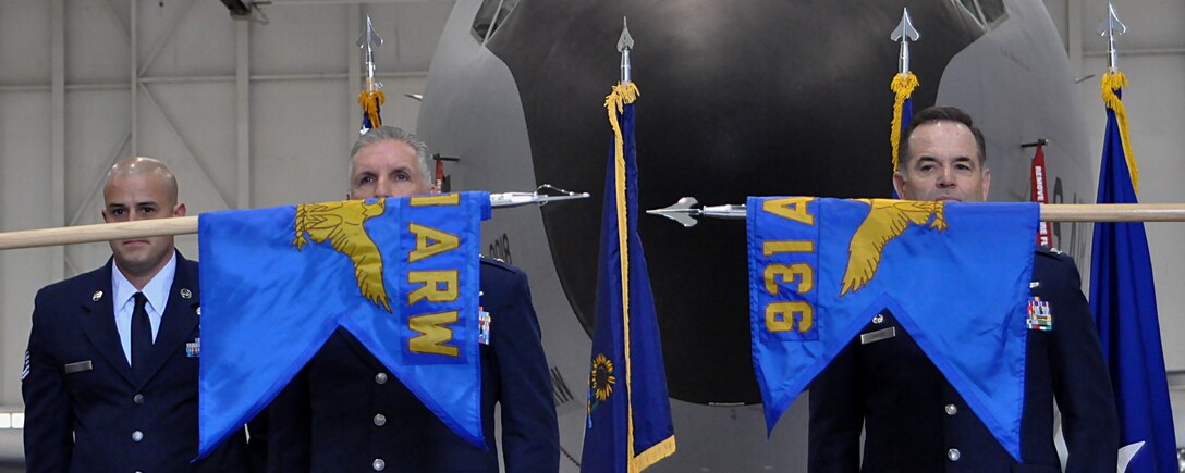 The 931st Air Refueling Wing flag is unfurled as the 931 Air Refueling Group flag is furled during a re-designation ceremony April 30, 2016, at McConnell Air Force Base, Kansas. Airmen with the 931 ARW aid their active-duty counterparts through vital contributions to the global mission of McConnell AFB. 