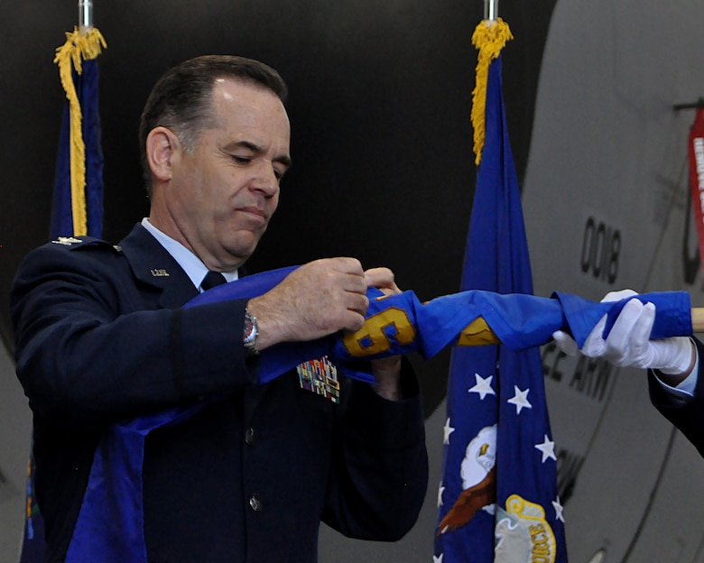 Col. Mark S. Larson, 931st Air Refueling Wing commander, encases the 931st Air Refueling Group flag during a re-designation ceremony April 30, 2016, at McConnell Air Force Base, Kansas. The flag isn't destroyed; instead it's encased and retired to serve as the physical representation of the 931 ARW's heritage. (U.S. Air Force photo by Senior Airman Preston Webb)