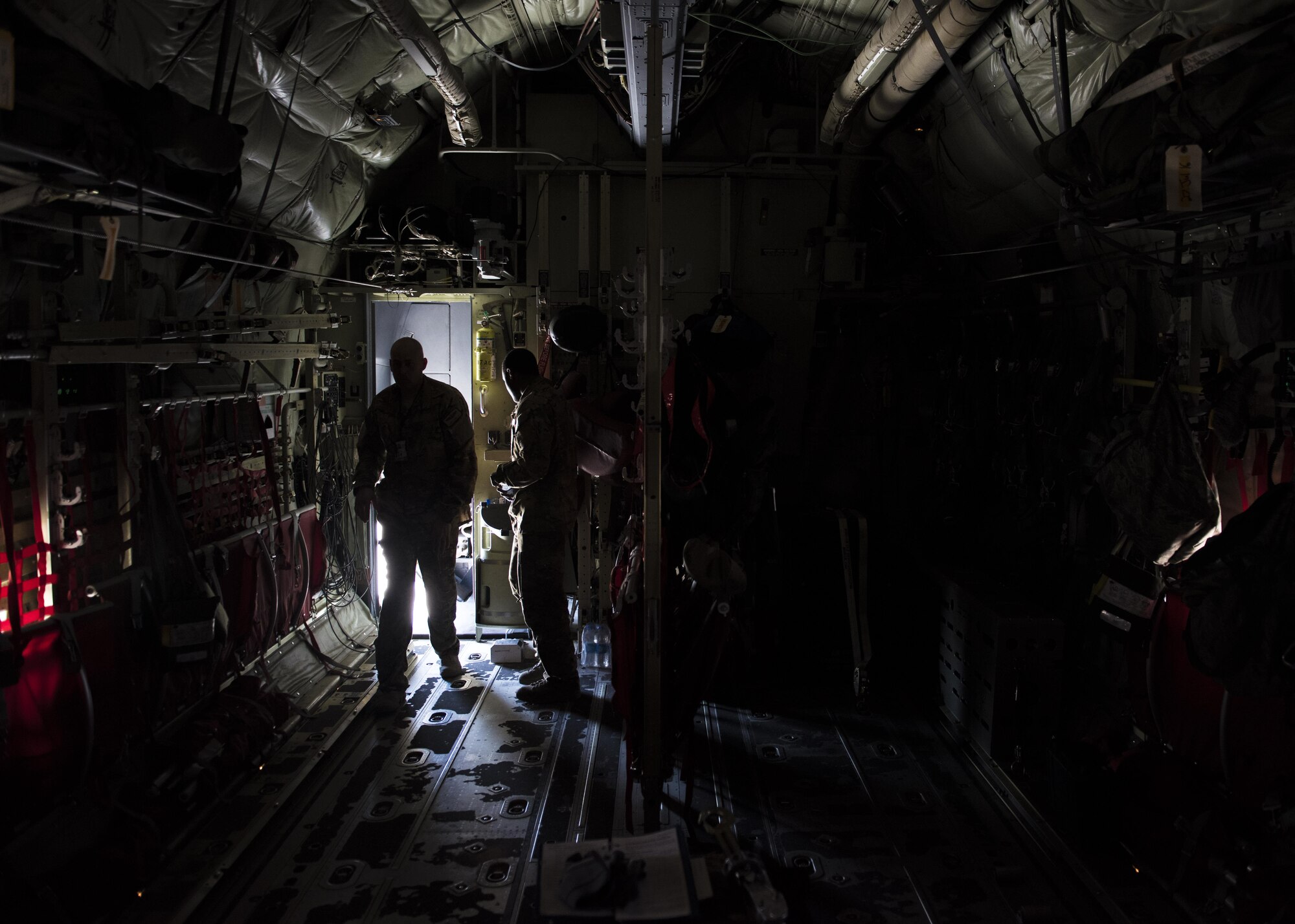 Senior Master Sgt. Kevin Letz, 774th Expeditionary Airlift Squadron loadmaster, walks towards the back of a C-130J Super Hercules during pre-flight checks at Bagram Airfield, Afghanistan, April 28, 2016. The C-130J Super Hercules is used for troop and cargo transport throughout Afghanistan. (U.S. Air Force photo by Senior Airman Justyn M. Freeman)