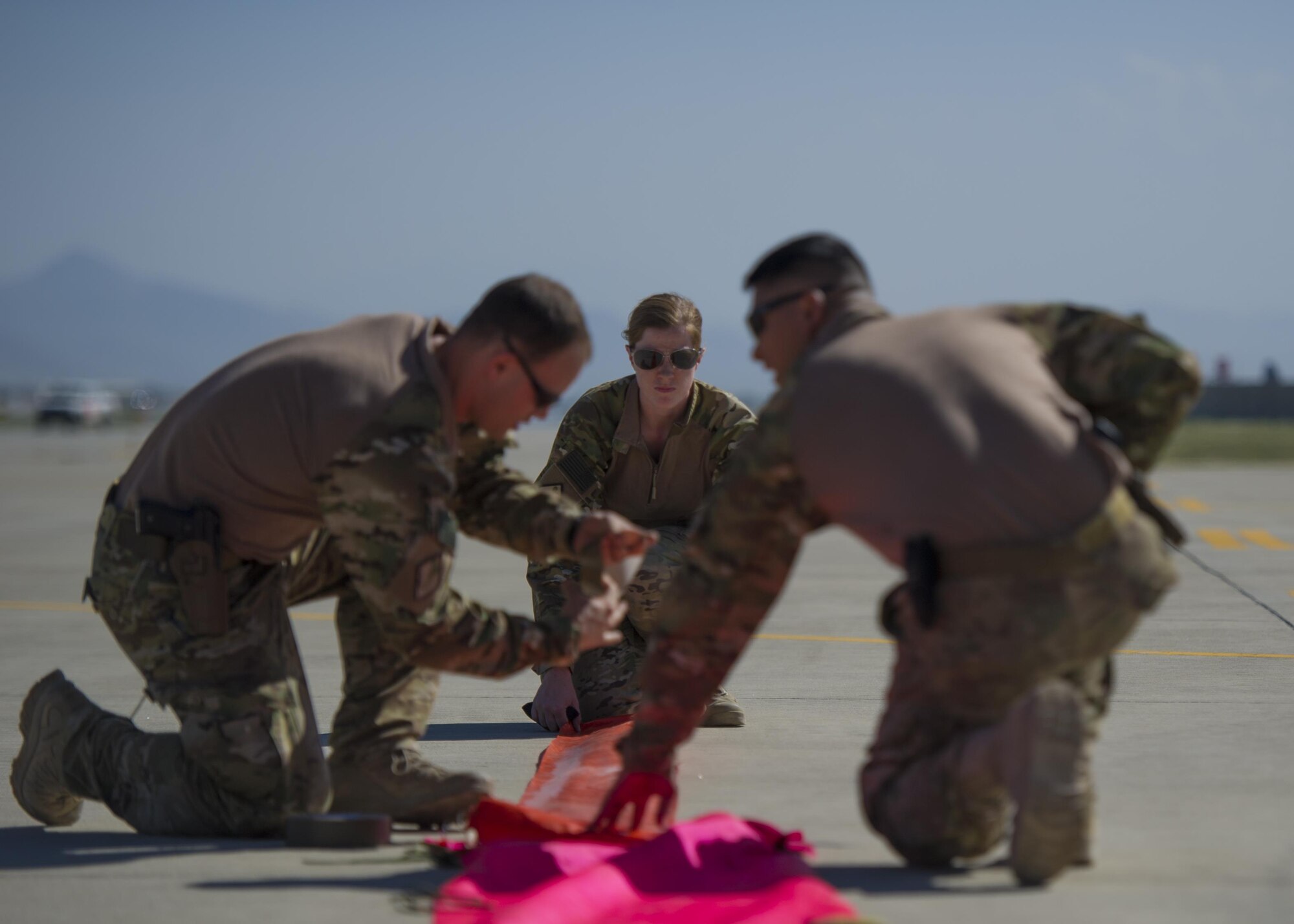 Pararescuemen from the 83rd Expeditionary Rescue Squadron lay down panels as other team members ready themselves to jump from a C-130J Super Hercules during a mission rehersal at Bagram Airfield, Afghanistan, April 28, 2016. Members of the 83rd Expeditionary Rescue Squadron are aided by the 774th Expeditionary Rescue Squadron as they conduct a mission rehersal to stay up to date on their training and tactics in support of Operation Freedom's Sentinel and NATO's Resolute Support Mission. (U.S. Air Force photo by Technical Sgt. Robert Cloys)