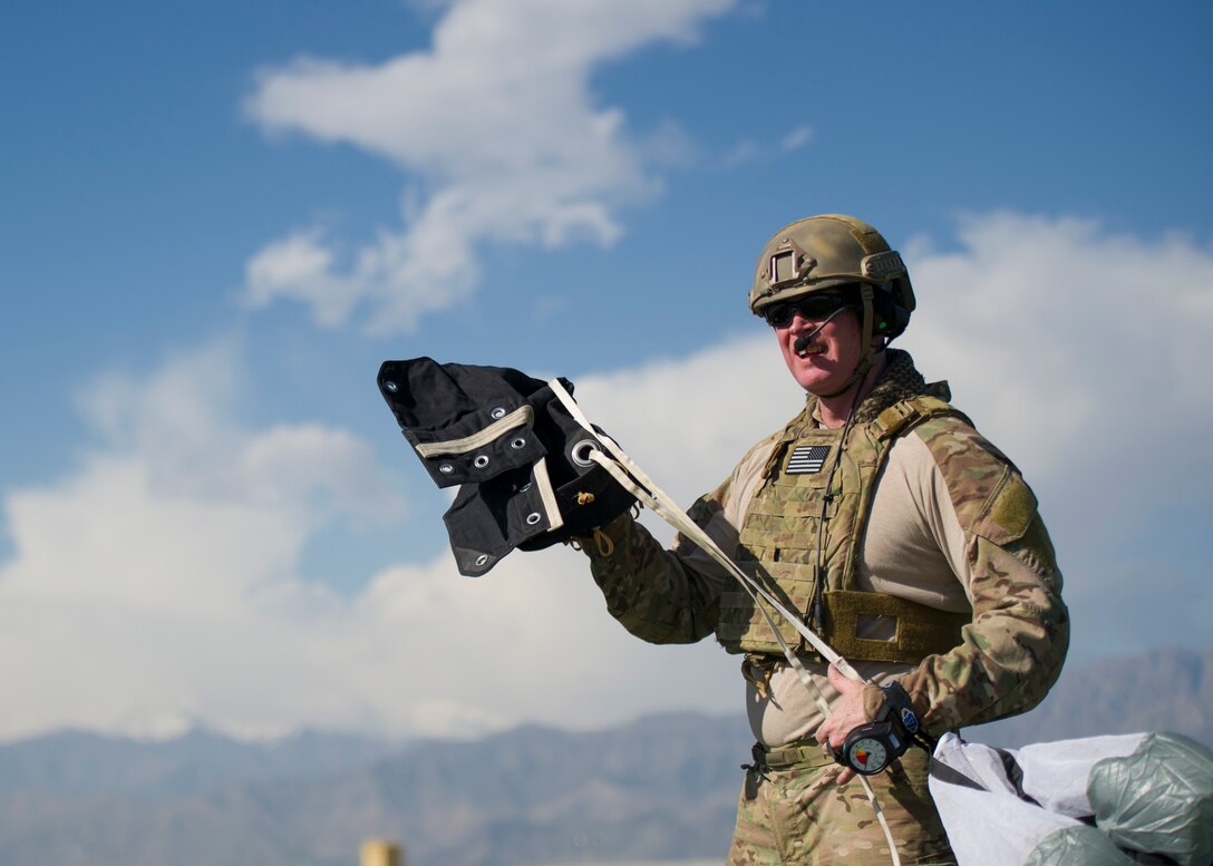 A pararescueman from the 83rd Expeditionary Rescue Squadron hauls in his parachute after a jump from a C-130J Super Hercules during a mission rehersal at Bagram Airfield, Afghanistan, April 28, 2016. Members of the 83rd Expeditionary Rescue Squadron are aided by the 774th Expeditionary Airlift Squadron as they conduct a mission rehersal to stay up to date on their training and tactics in support of Operation Freedom's Sentinel and NATO's Resolute Support Mission. (U.S. Air Force photo by Technical Sgt. Robert Cloys)
