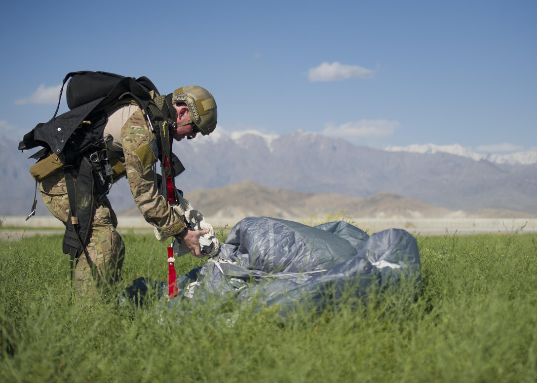 A pararescueman from the 83rd Expeditionary Rescue Squadron hauls in his parachute after a jump from a C-130J Super Hercules during a mission rehersal at Bagram Airfield, Afghanistan, April 28, 2016. Members of the 83rd Expeditionary Rescue Squadron are aided by the 774th Expeditionary Airlift Squadron as they conduct a mission rehersal to stay up to date on their training and tactics in support of Operation Freedom's Sentinel and NATO's Resolute Support Mission. (U.S. Air Force photo by Technical Sgt. Robert Cloys)