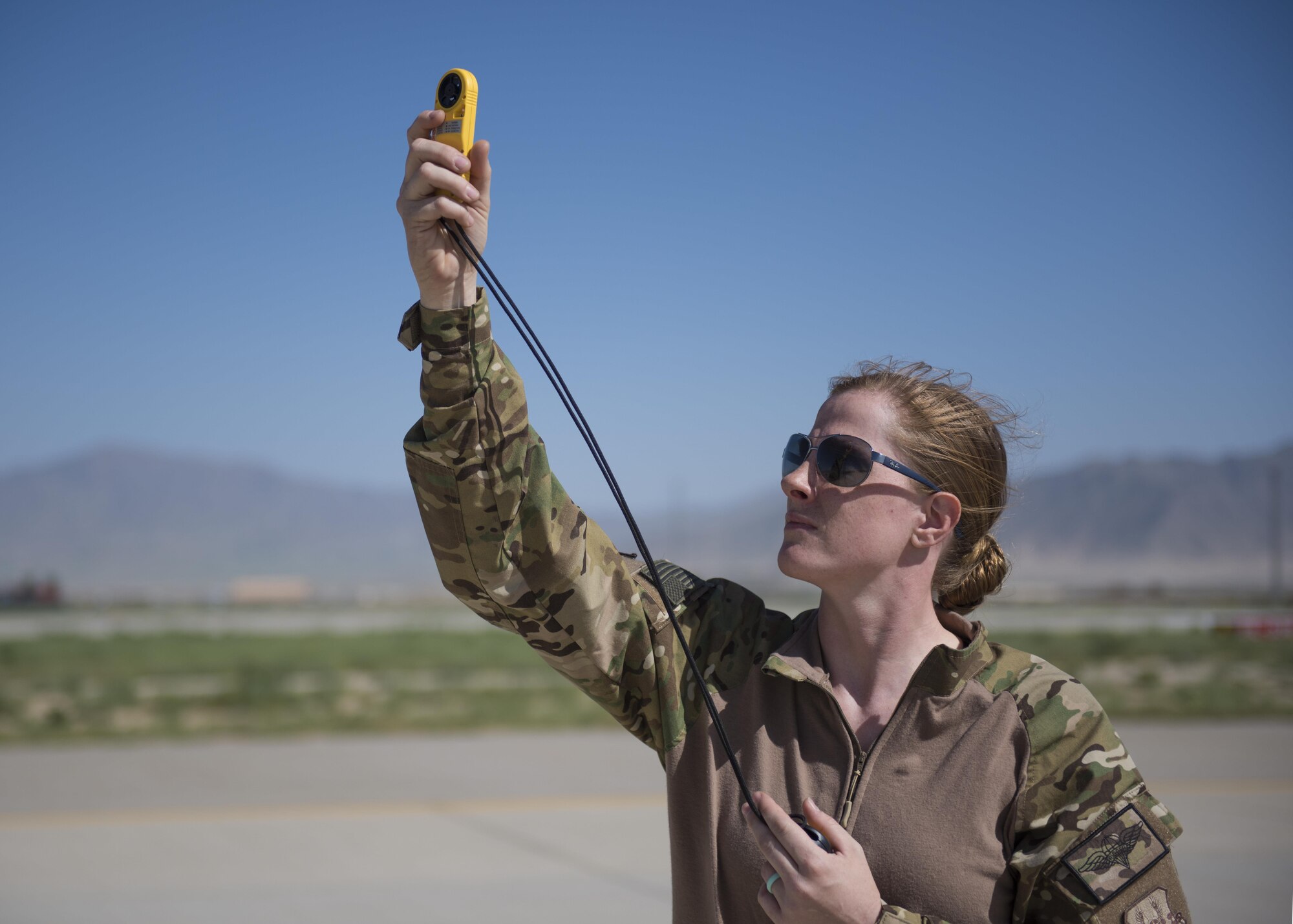 A pararescueman from the 83rd Expeditionary Rescue Squadron tests the wind as team members prepare to jump from a C-130J Super Hercules during a mission rehersal at Bagram Airfield, Afghanistan, April 28, 2016. Testing the wind allows the pararescuemen to be better prepared when they jump from aircraft towards a specific drop zone. (U.S. Air Force photo by Technical Sgt. Robert Cloys)