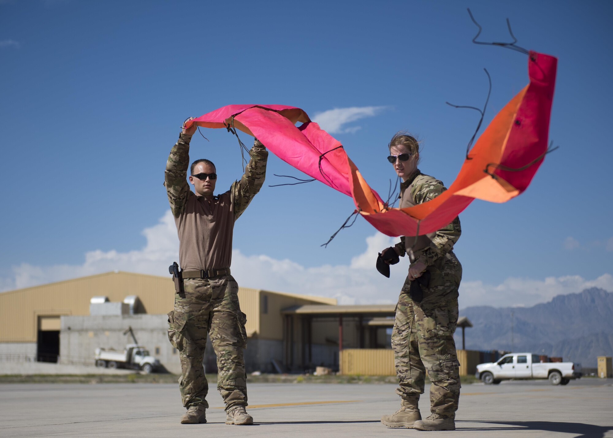 Pararescuemen from the 83rd Expeditionary Rescue Squadron lay down panels as other team members ready themselves to jump from a C-130J Super Hercules during a mission rehersal at Bagram Airfield, Afghanistan, April 28, 2016. Members of the 83rd Expeditionary Rescue Squadron are aided by the 774th Expeditionary Rescue Squadron as they conduct a mission rehersal to stay up to date on their training and tactics in support of Operation Freedom's Sentinel and NATO's Resolute Support Mission. (U.S. Air Force photo by Technical Sgt. Robert Cloys)